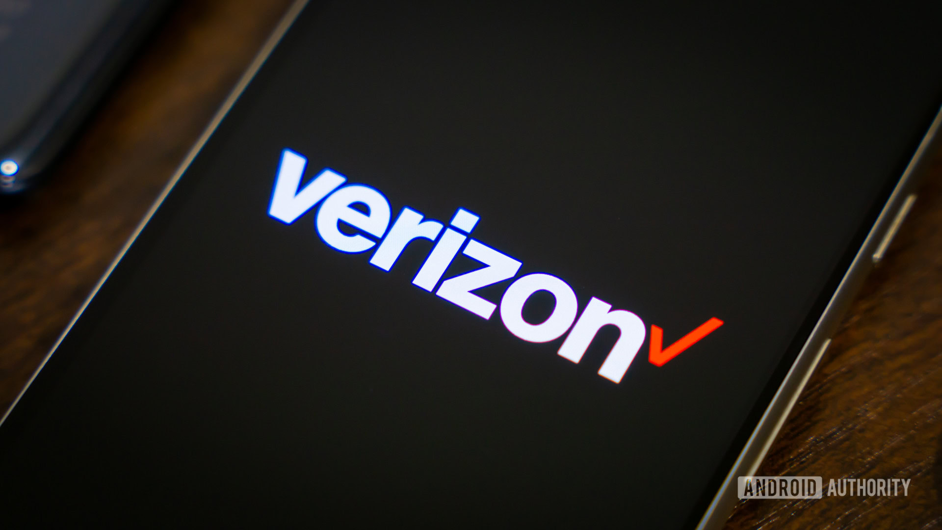 Verizon logo on smartphone, next to other devices (2)
