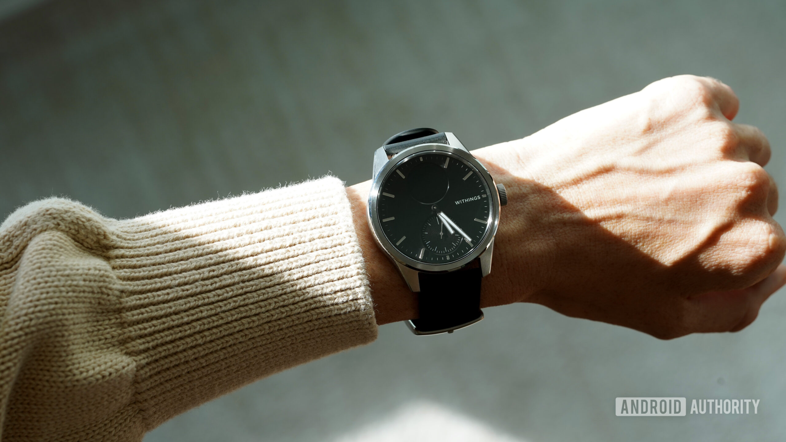 A Withings ScanWatch 2 on a users wrist looks like a regular analog wearable.