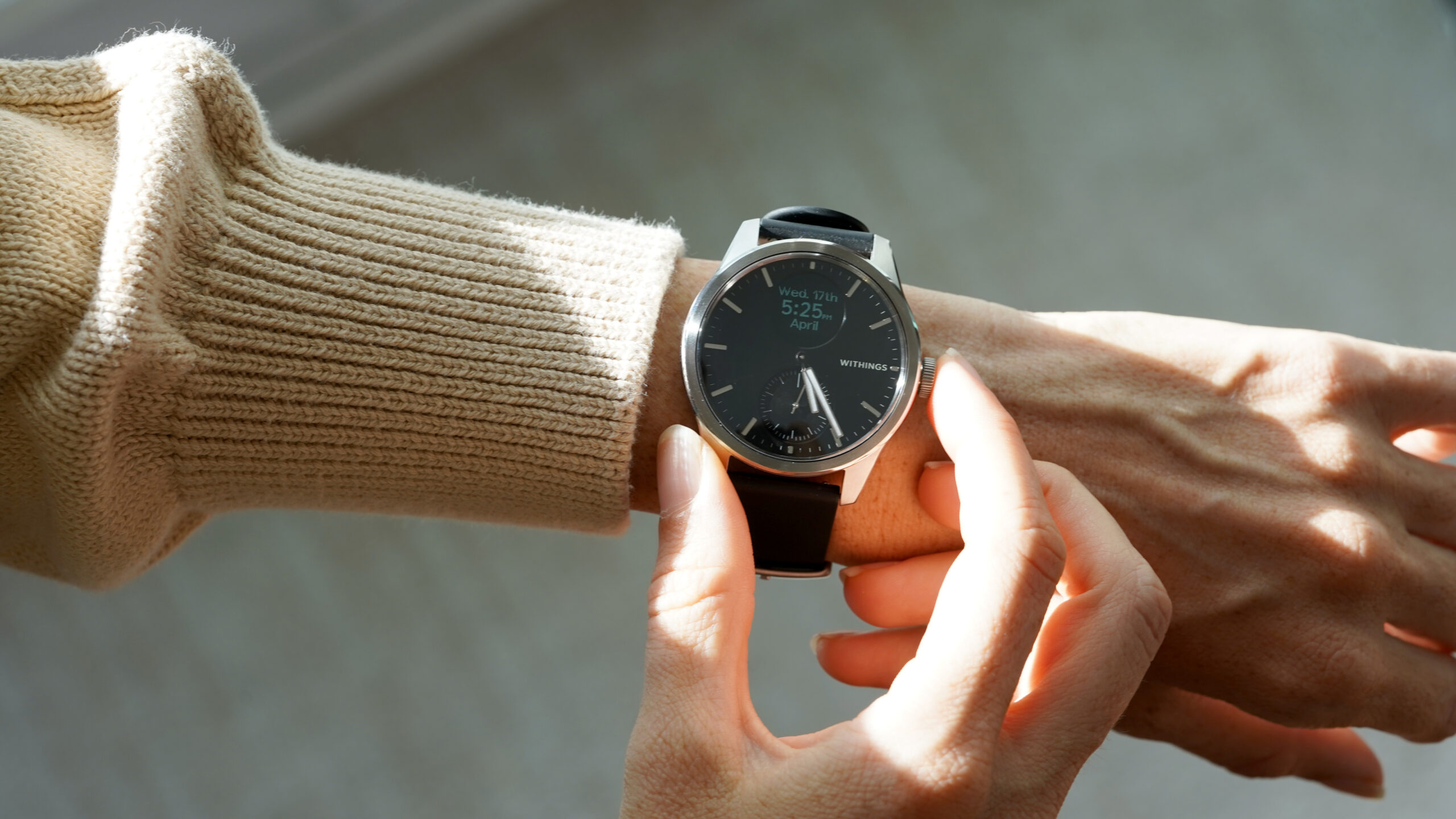 A user activates the OLED display on their Withings ScanWatch 2.
