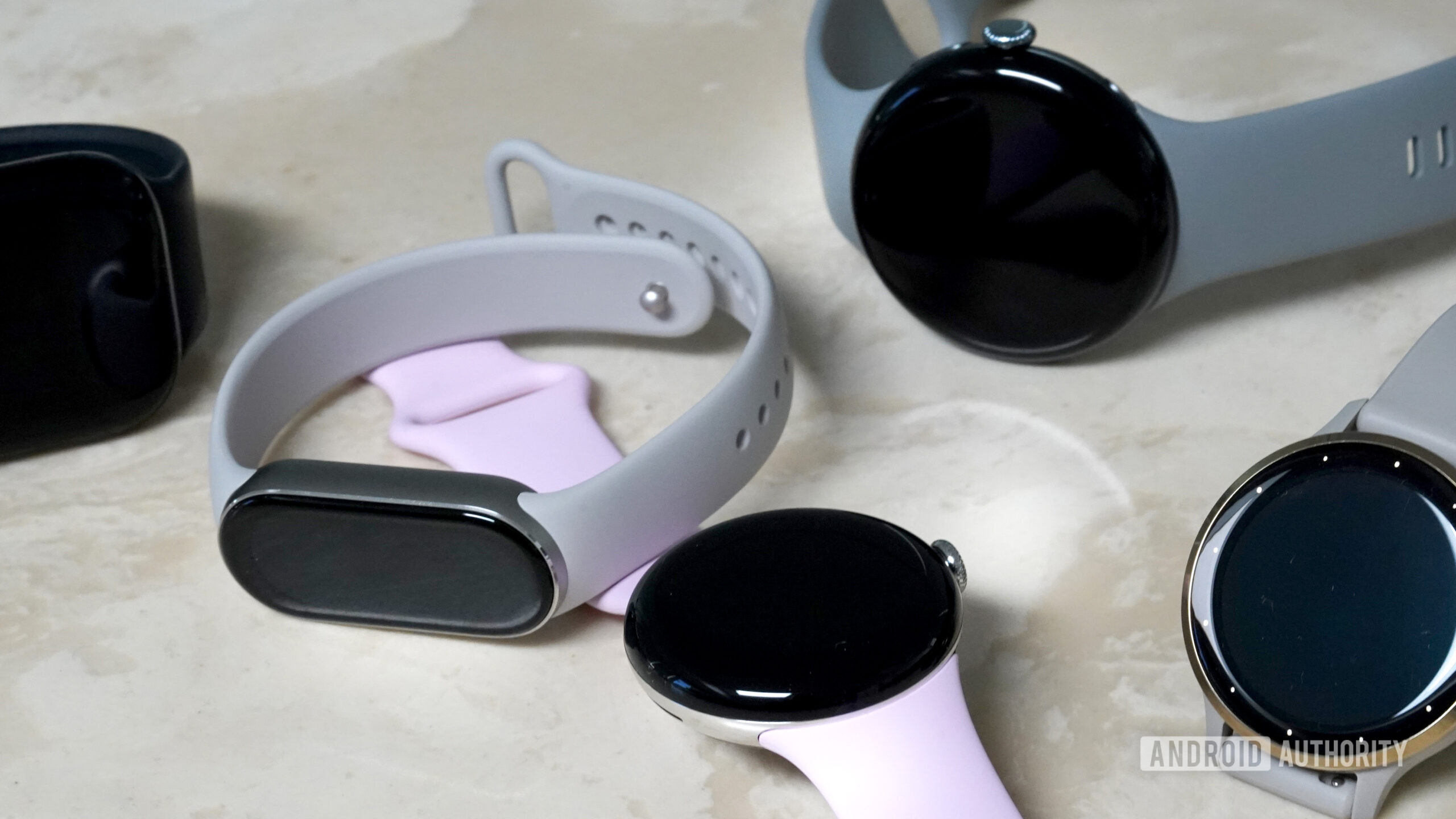 A variety of Fitbit alternatives rest on a table.