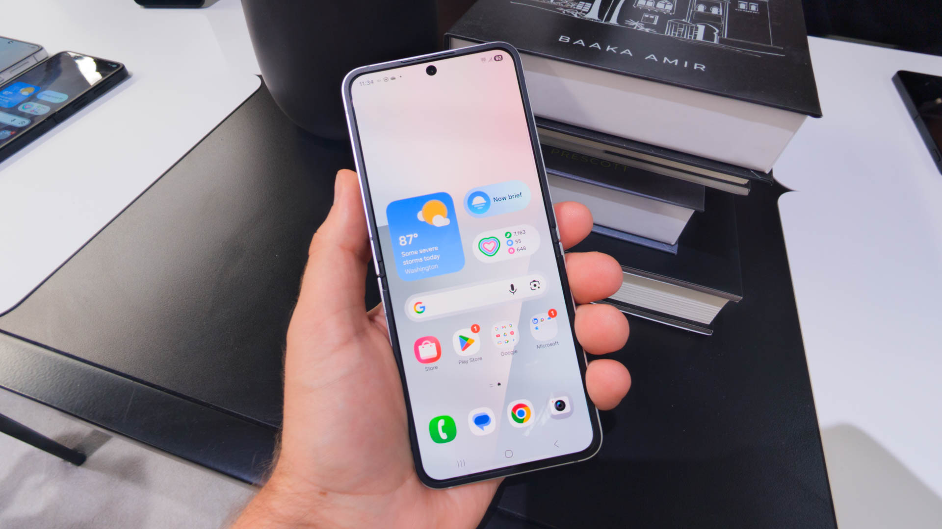 Samsung Galaxy Z Flip 7 FE in White in hand unfolded Samsung Galaxy Z Flip 7 FE in White in hand unfolded