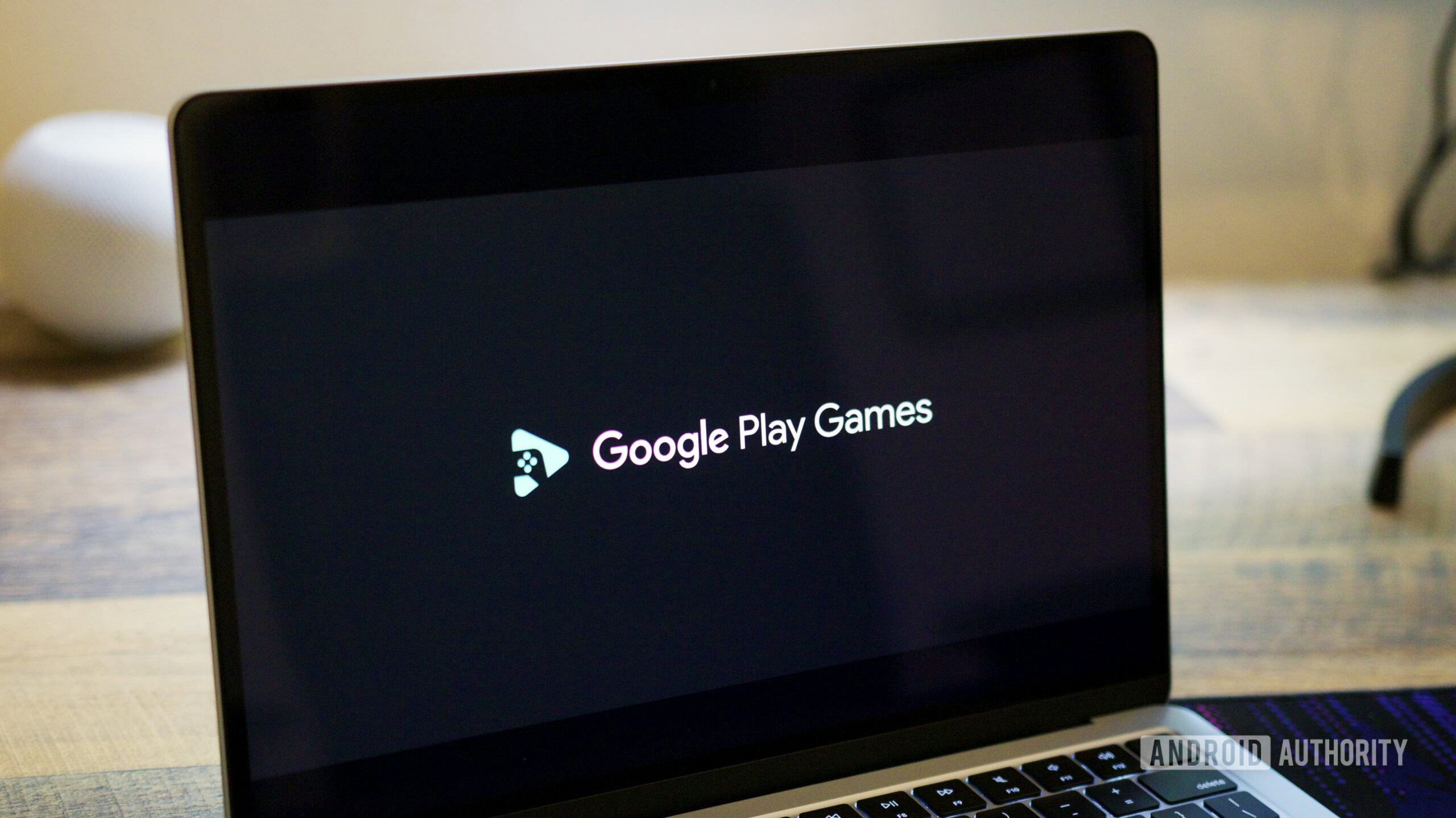 Google Play Games logo on a laptop screen.