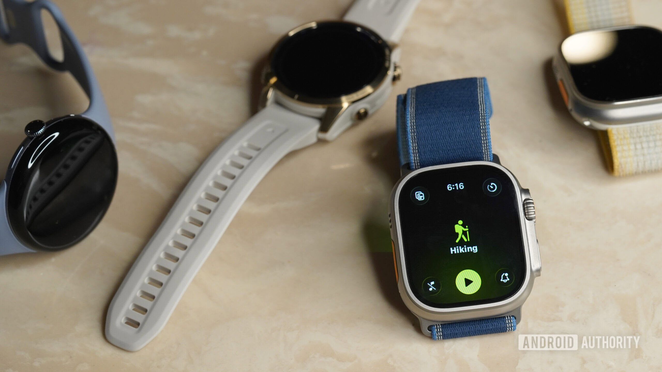 An Apple Watch Ultra 3 rests among alternatives.
