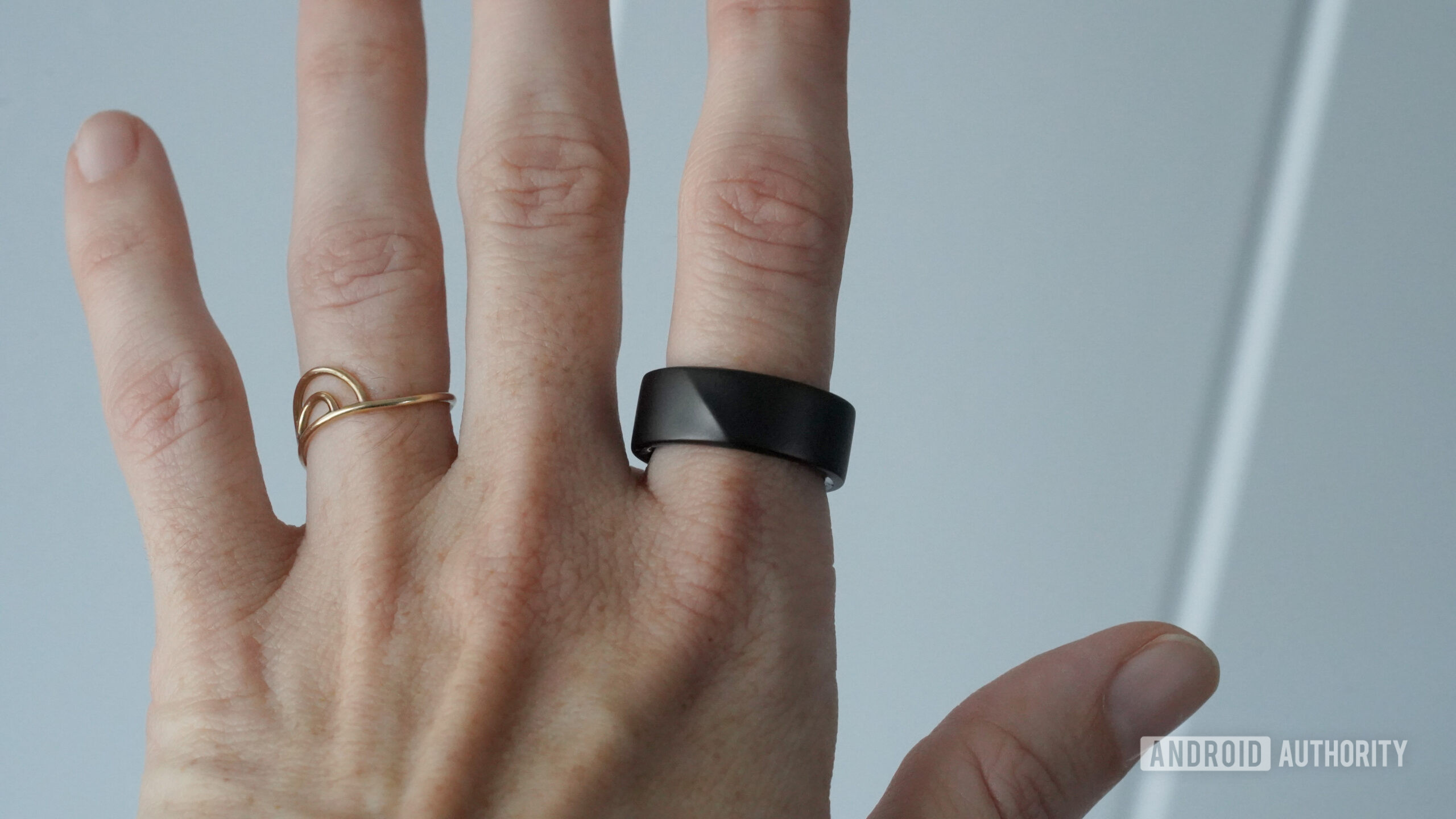 A Luna Ring 2 sits on a user's index finger.