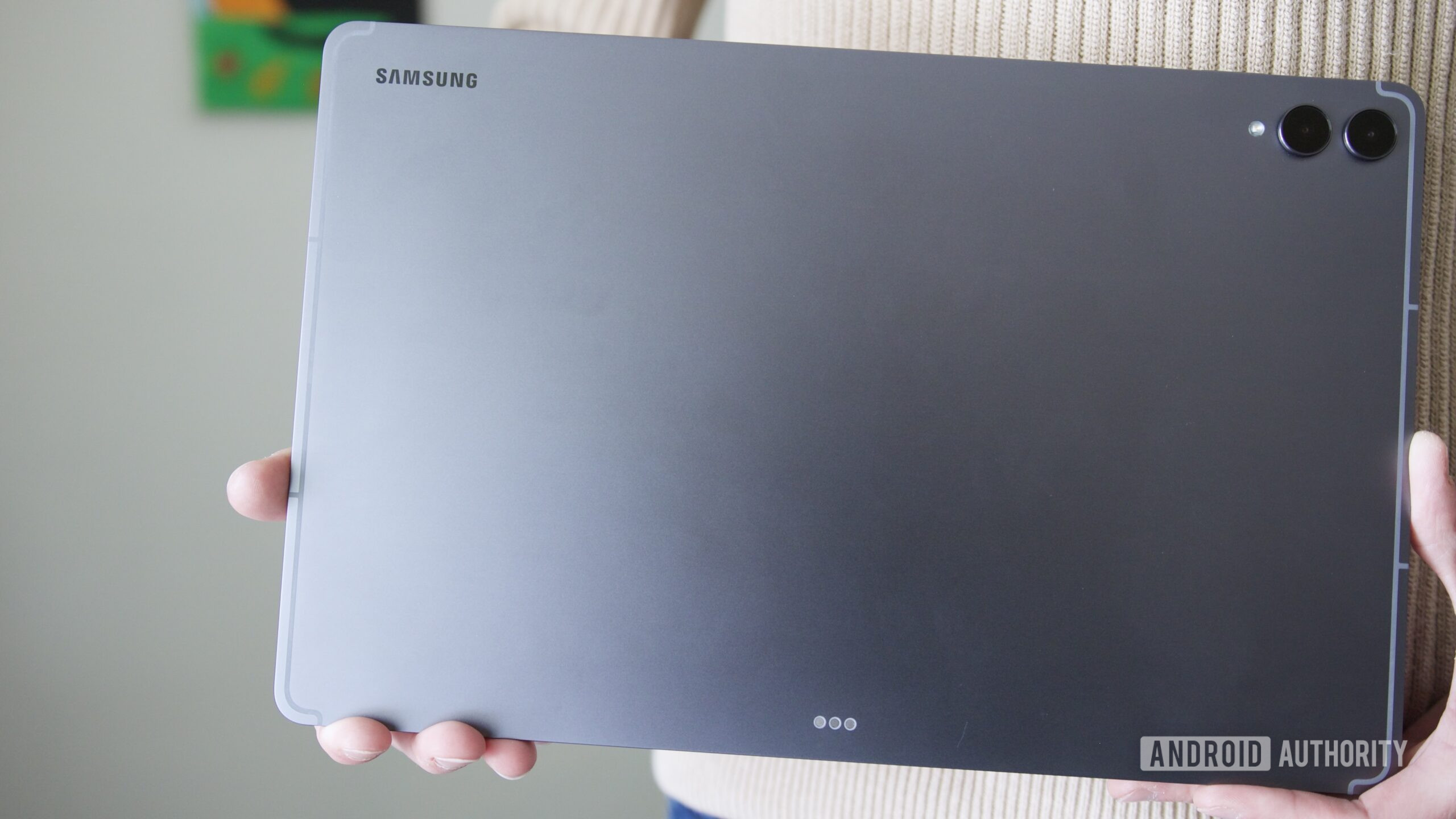 samsung galaxy tab s11 ultra review 6 Someone holding the Samsung Galaxy Tab S11 Ultra, showing the back of the tablet.