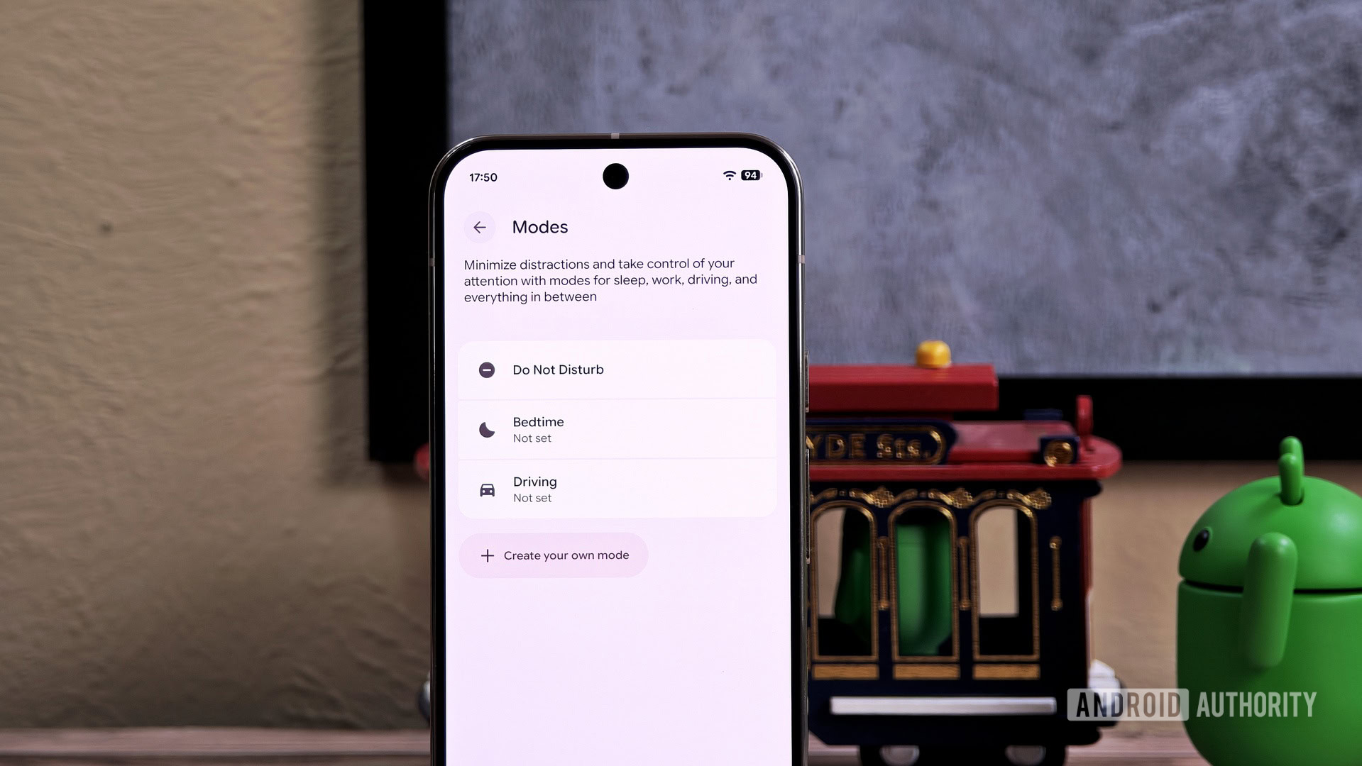 Modes settings on an Android phone with the Bot mascot in the background Modes settings on an Android phone with the Bot mascot in the background