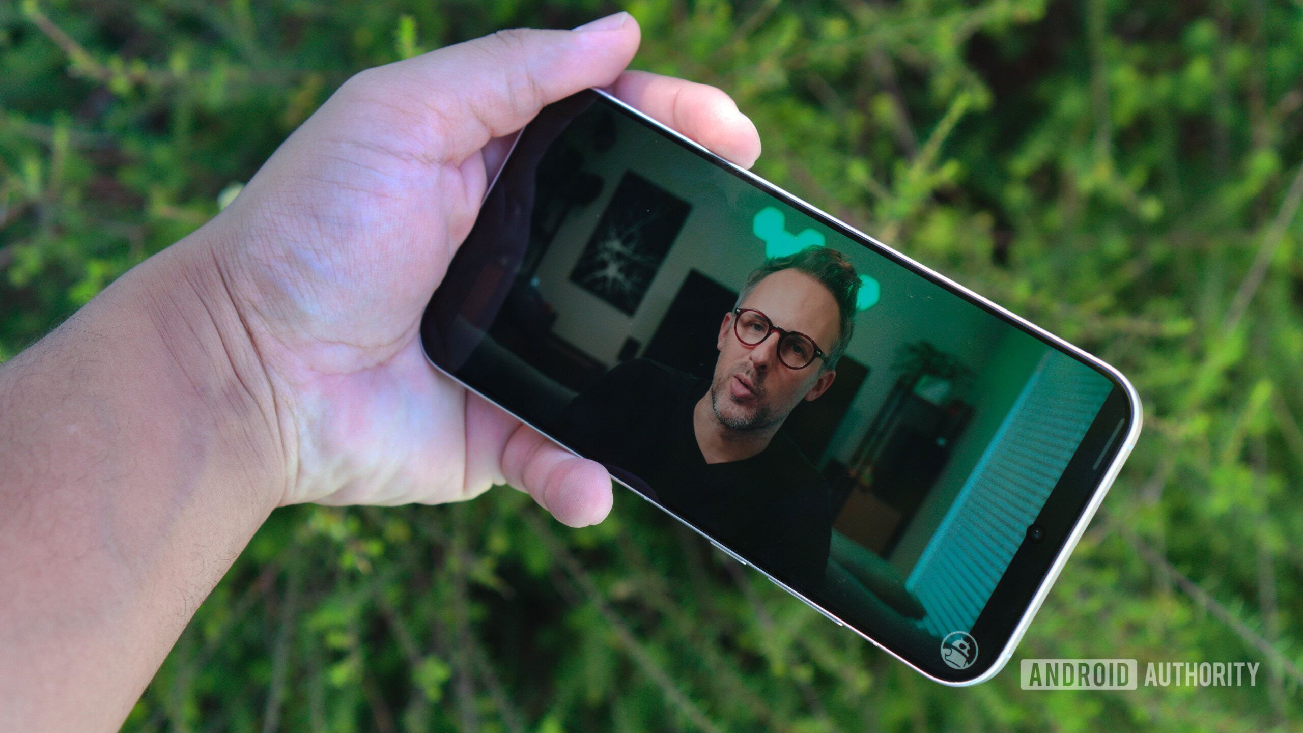 realme GT8 Pro in hand watching video