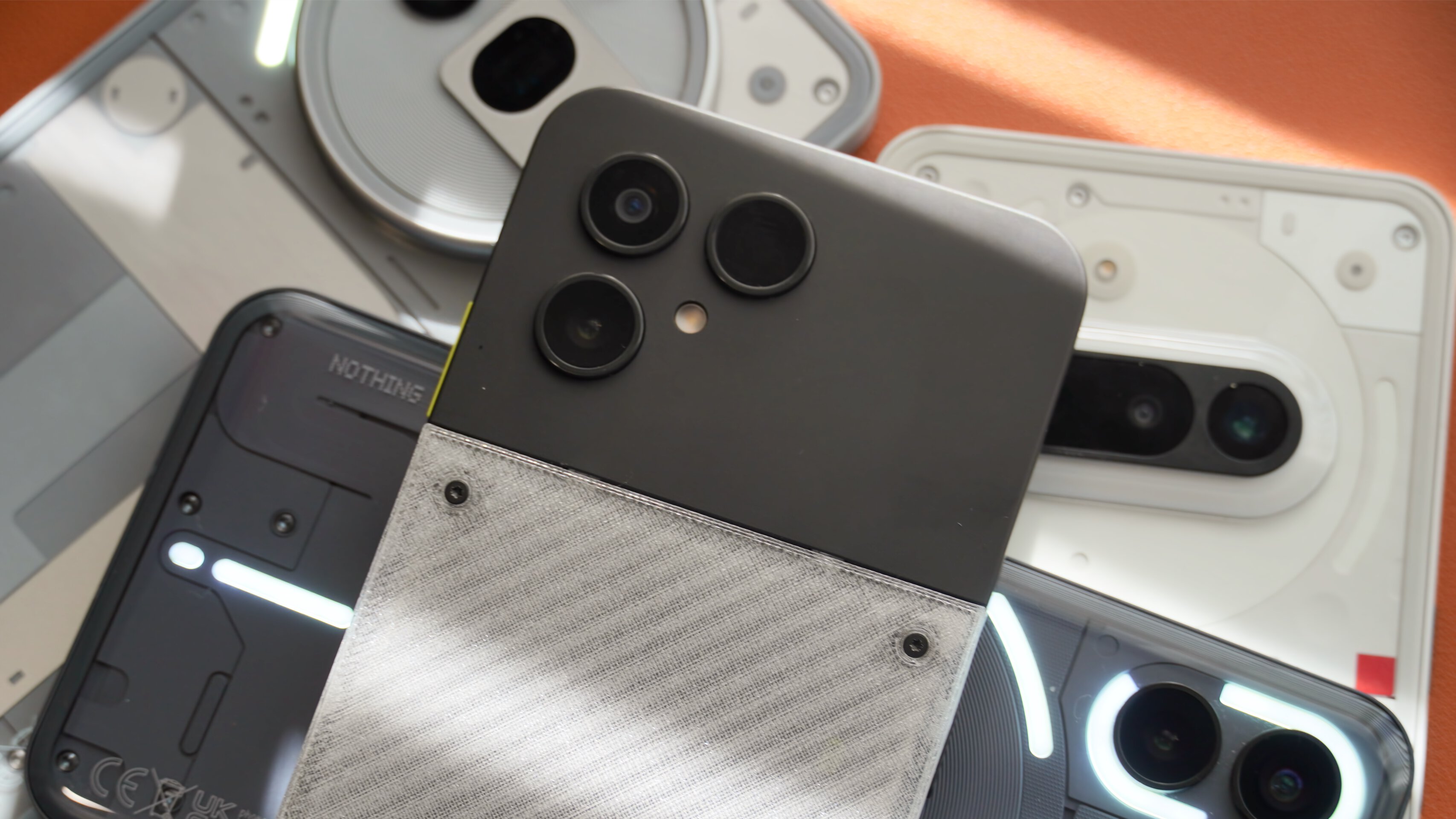 Fairphone 6 Nothing Phone Comparison 1 A close-up of the Fairphone 6 atop multiple Nothing phones.