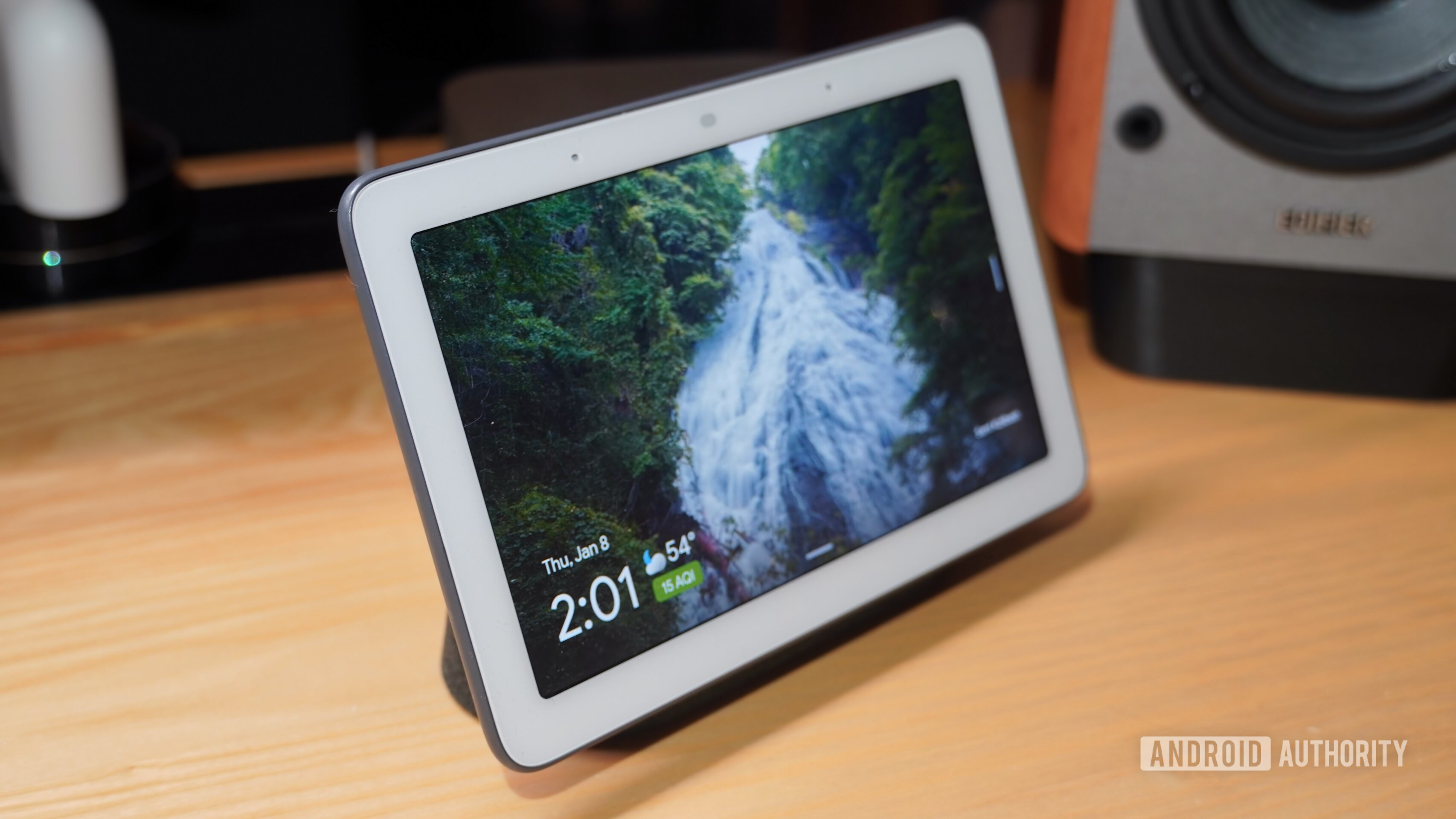 An angled Nest Hub on a desk.