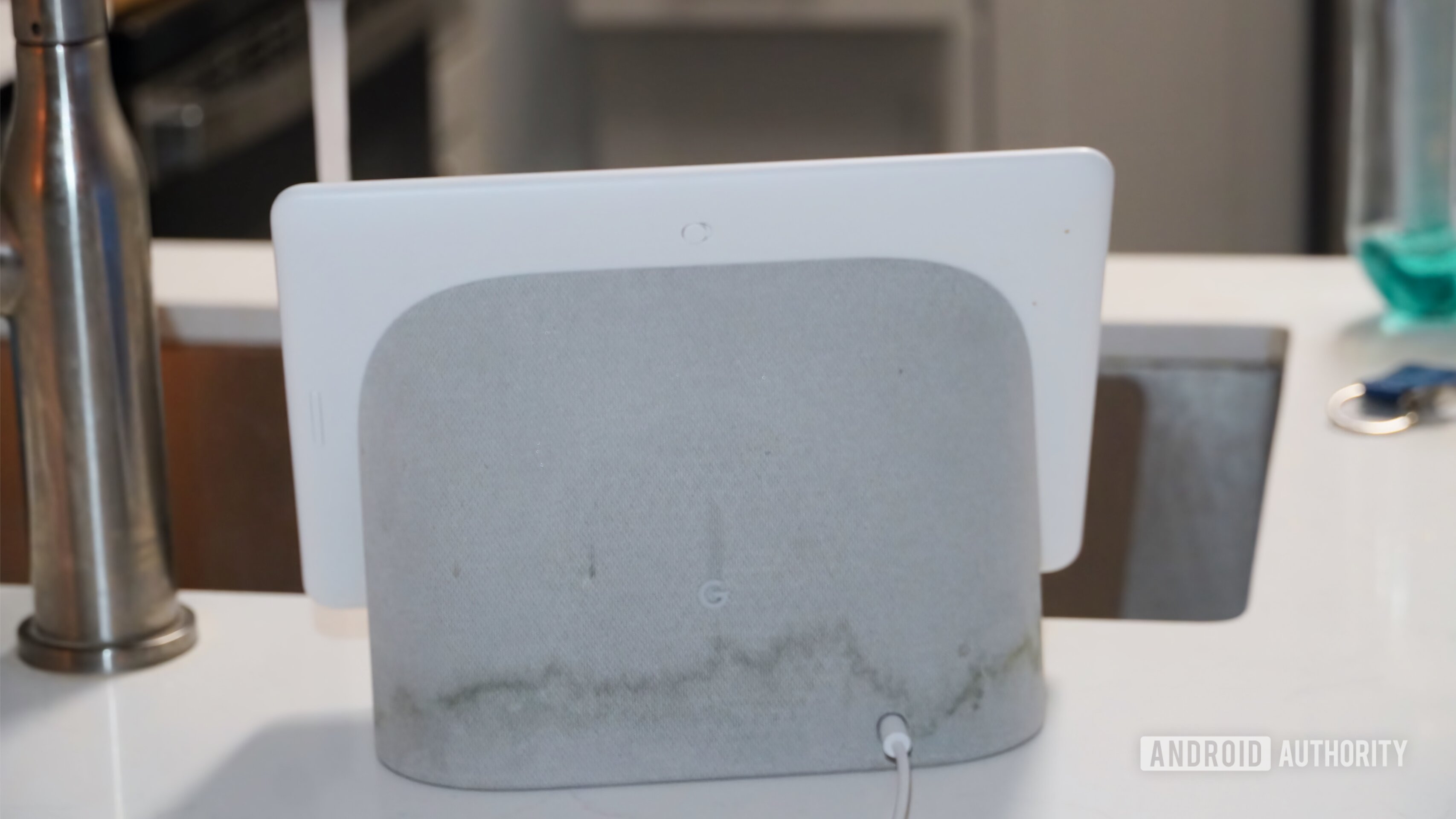 Water stains on a Nest Hub Max near a sink with running water.