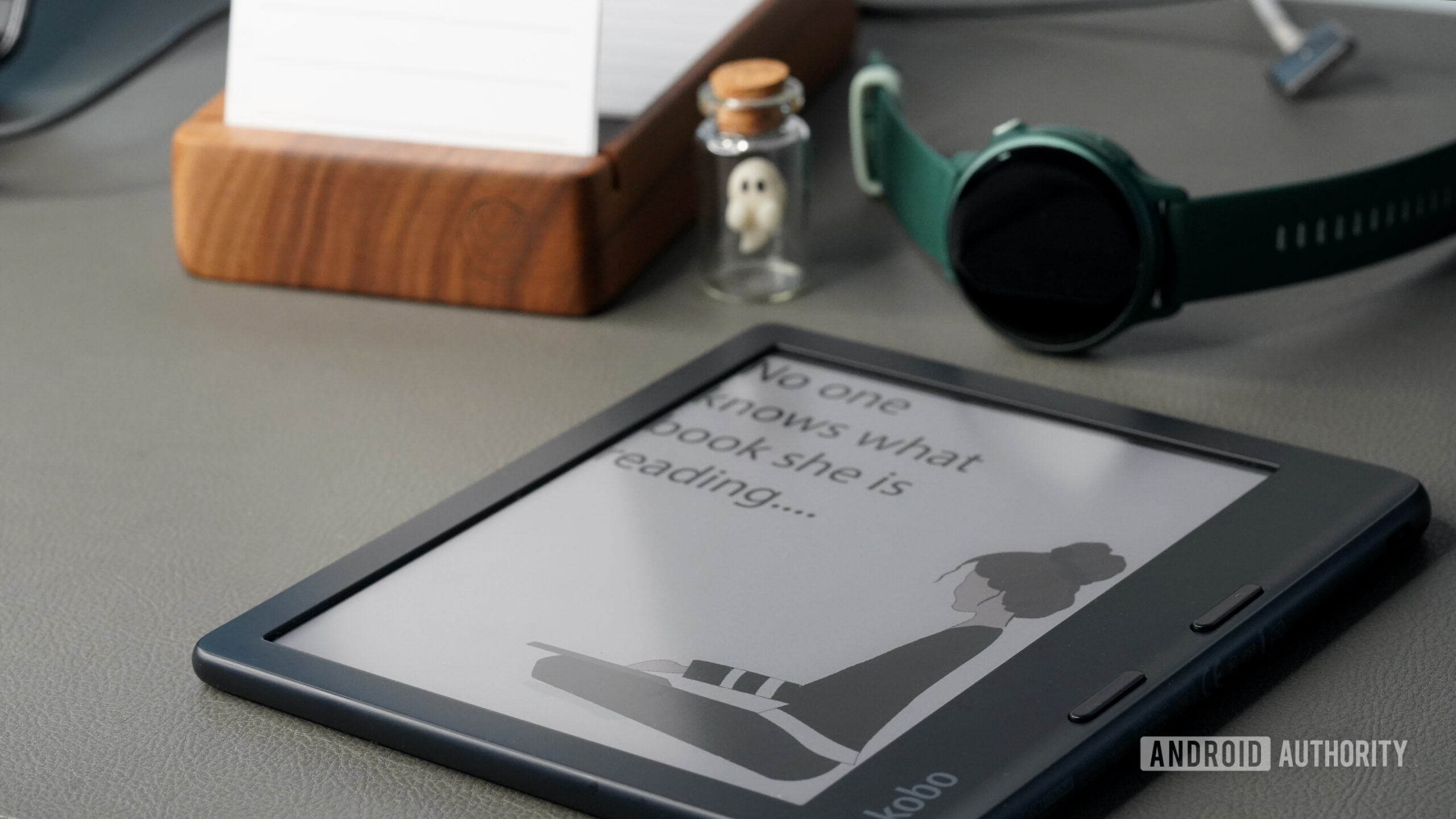 A Kobo Libra Colour displays a custom screensaver.