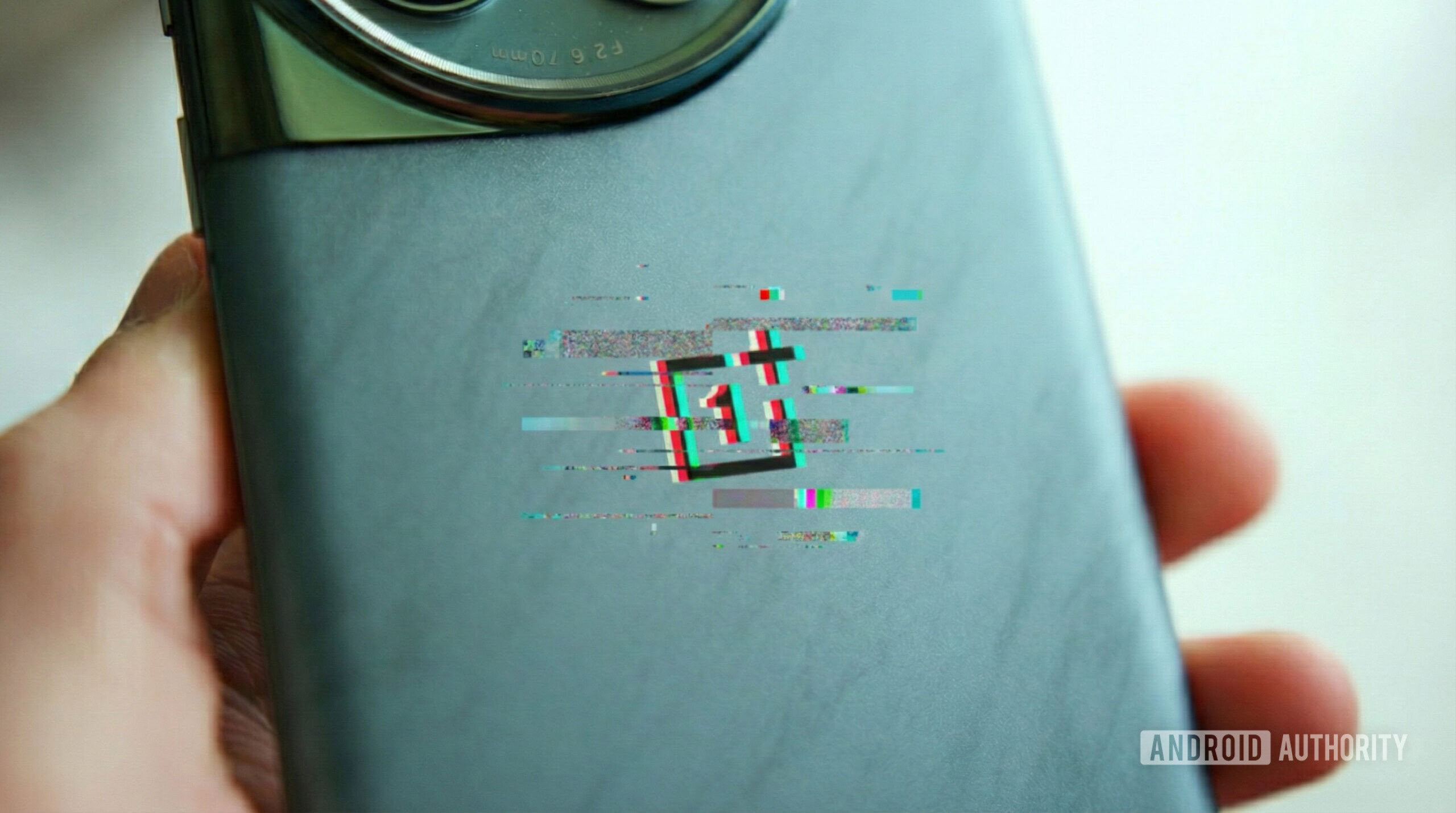The back of a OnePlus phone with a glitched-out effect on the OnePlus logo.