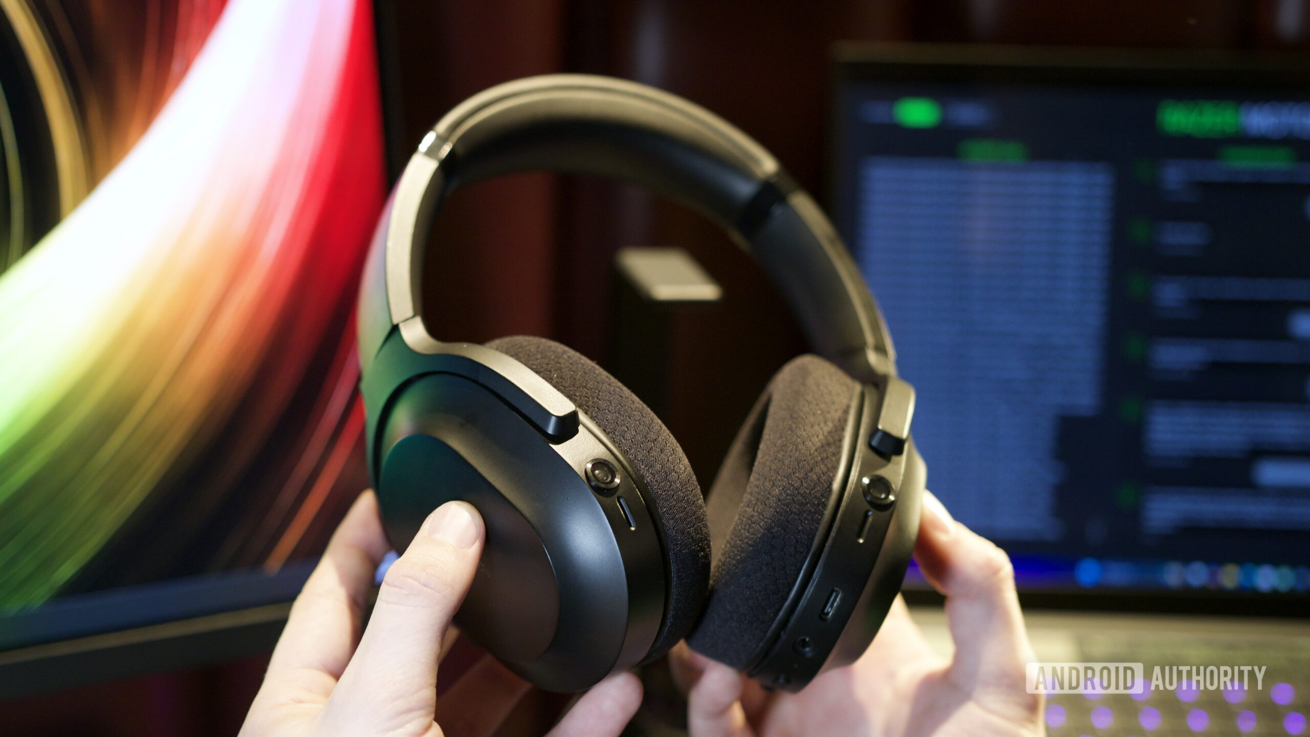 Someone holding Razer's Project Motoko headphones.