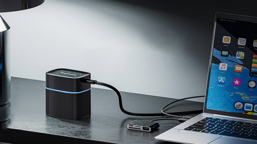 Maxfree Rechargeable 4 AAA and 4 AA Batteries on table charging laptop