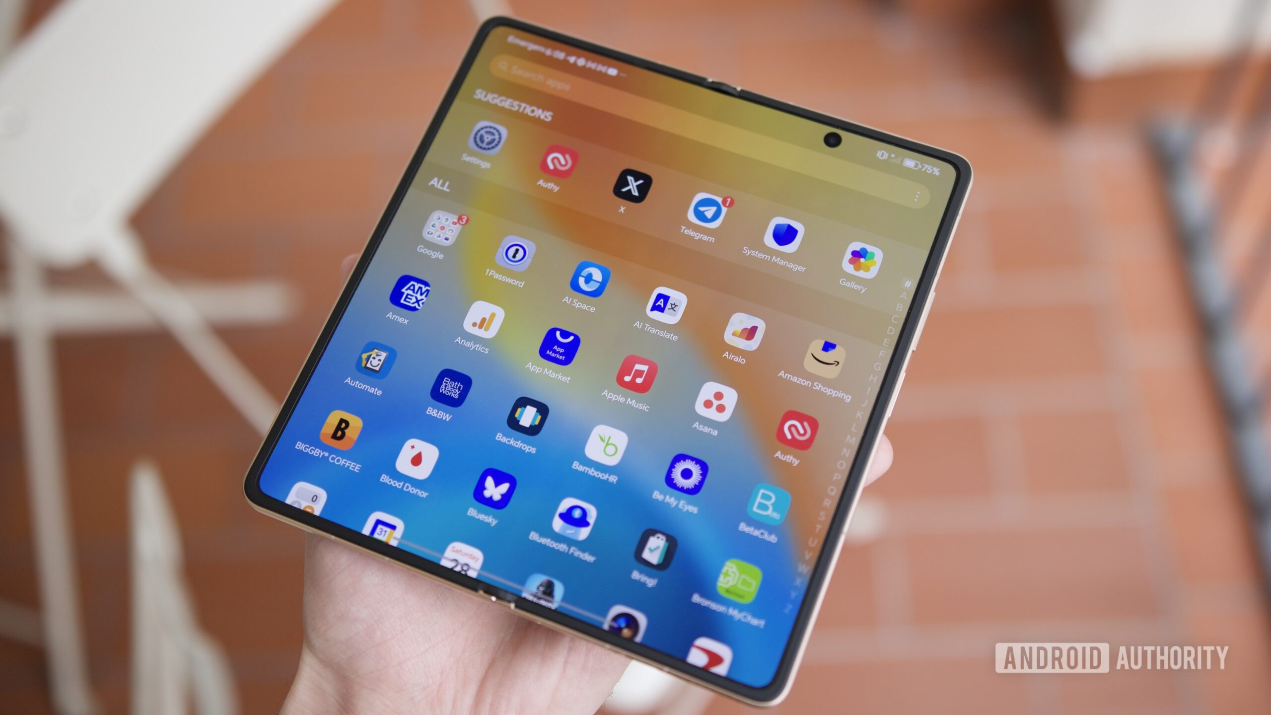 Someone holding the HONOR Magic V6 with the inner display open.