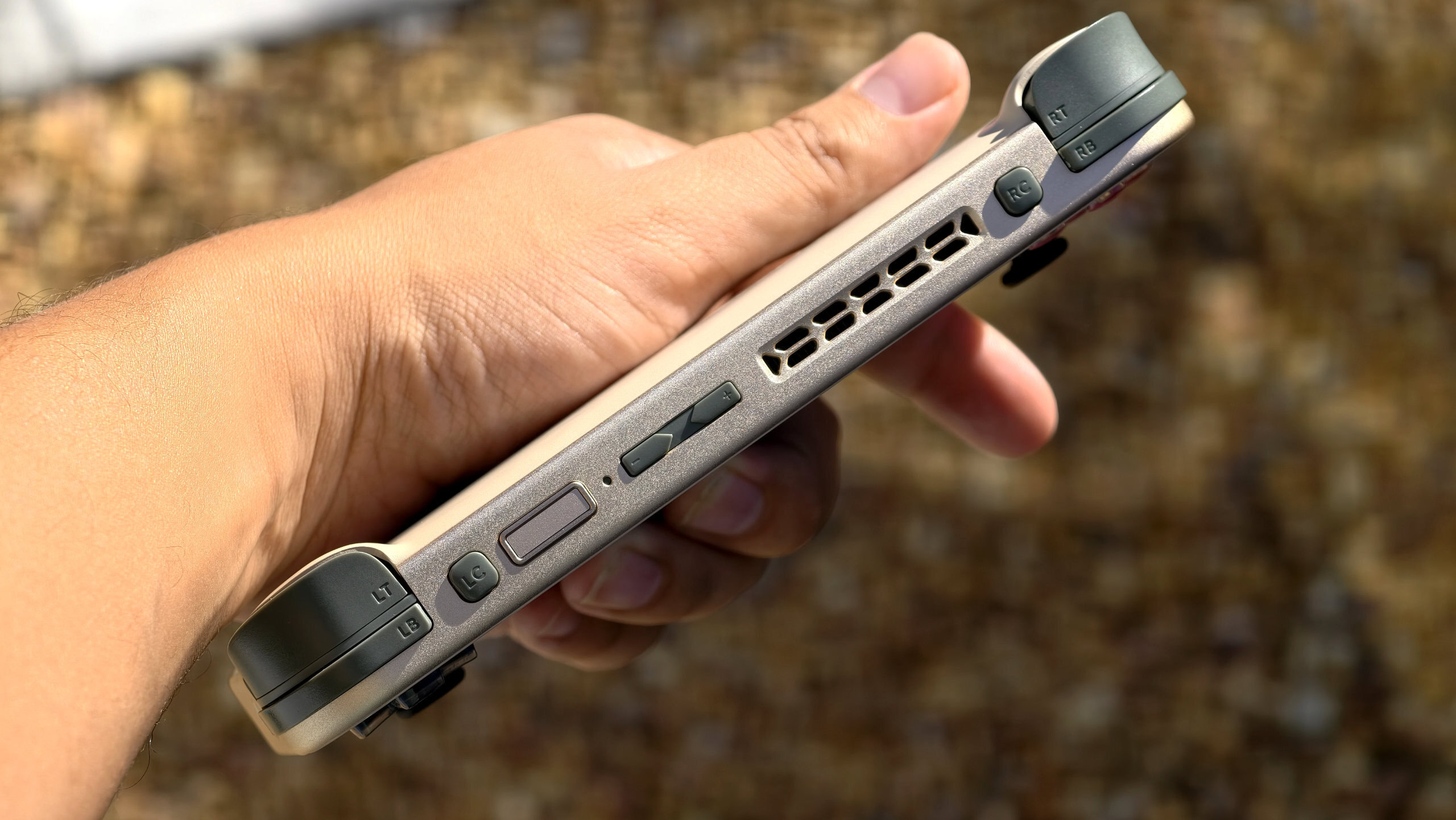 AYANEO Pocket S Mini in hand showing top edge