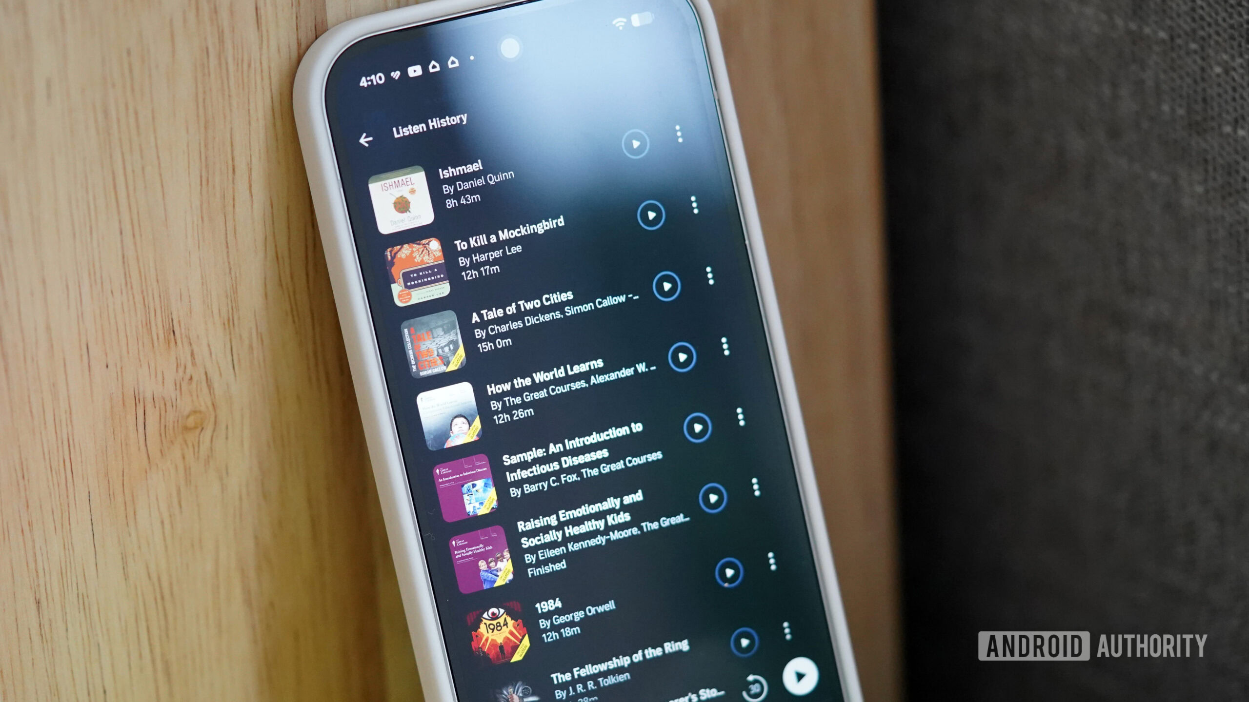 A user's phone displays their Listening History in the Audible app.
