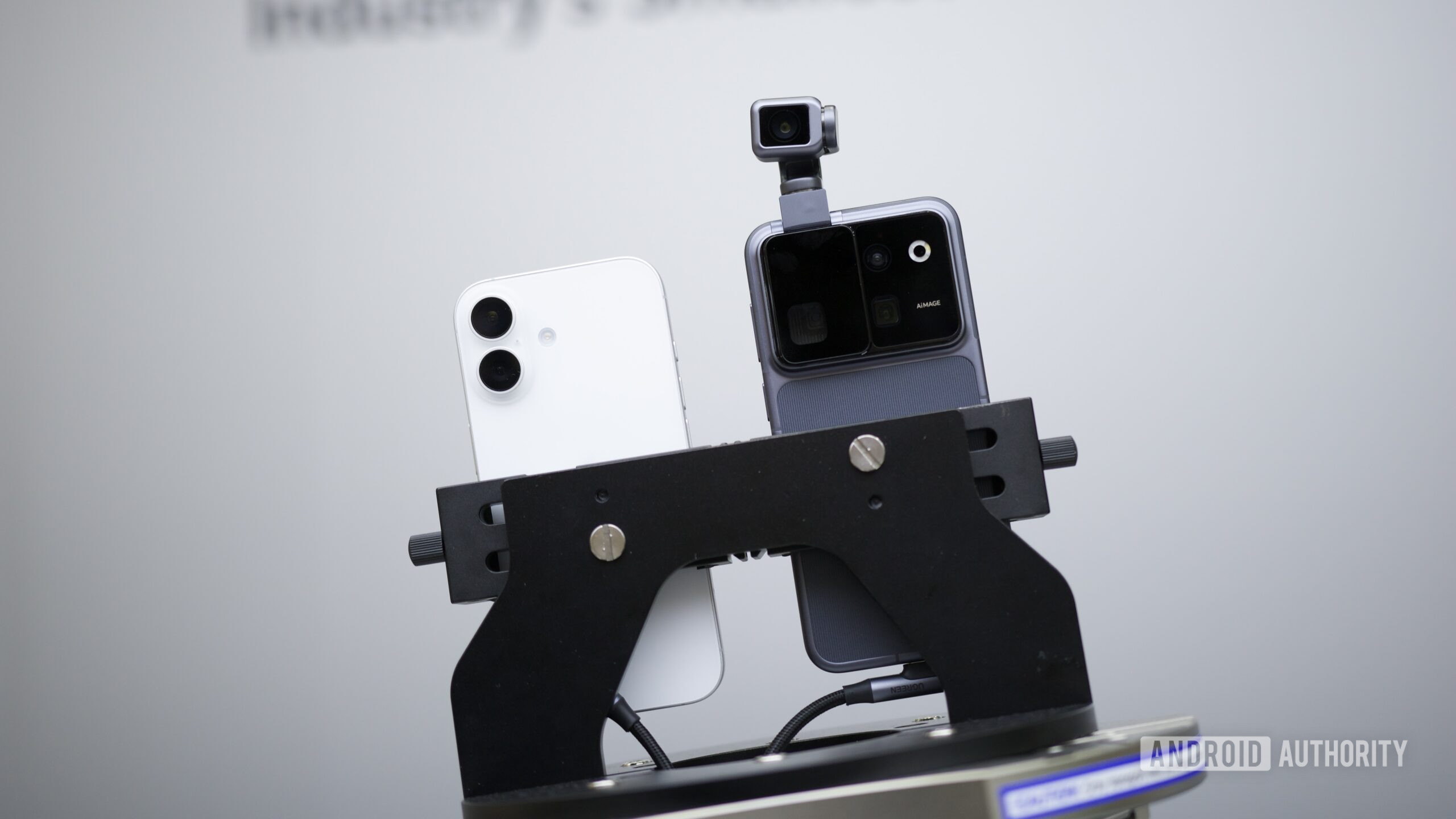 The HONOR Robot Phone next to an iPhone, showing the difference in video stabilization between the two.