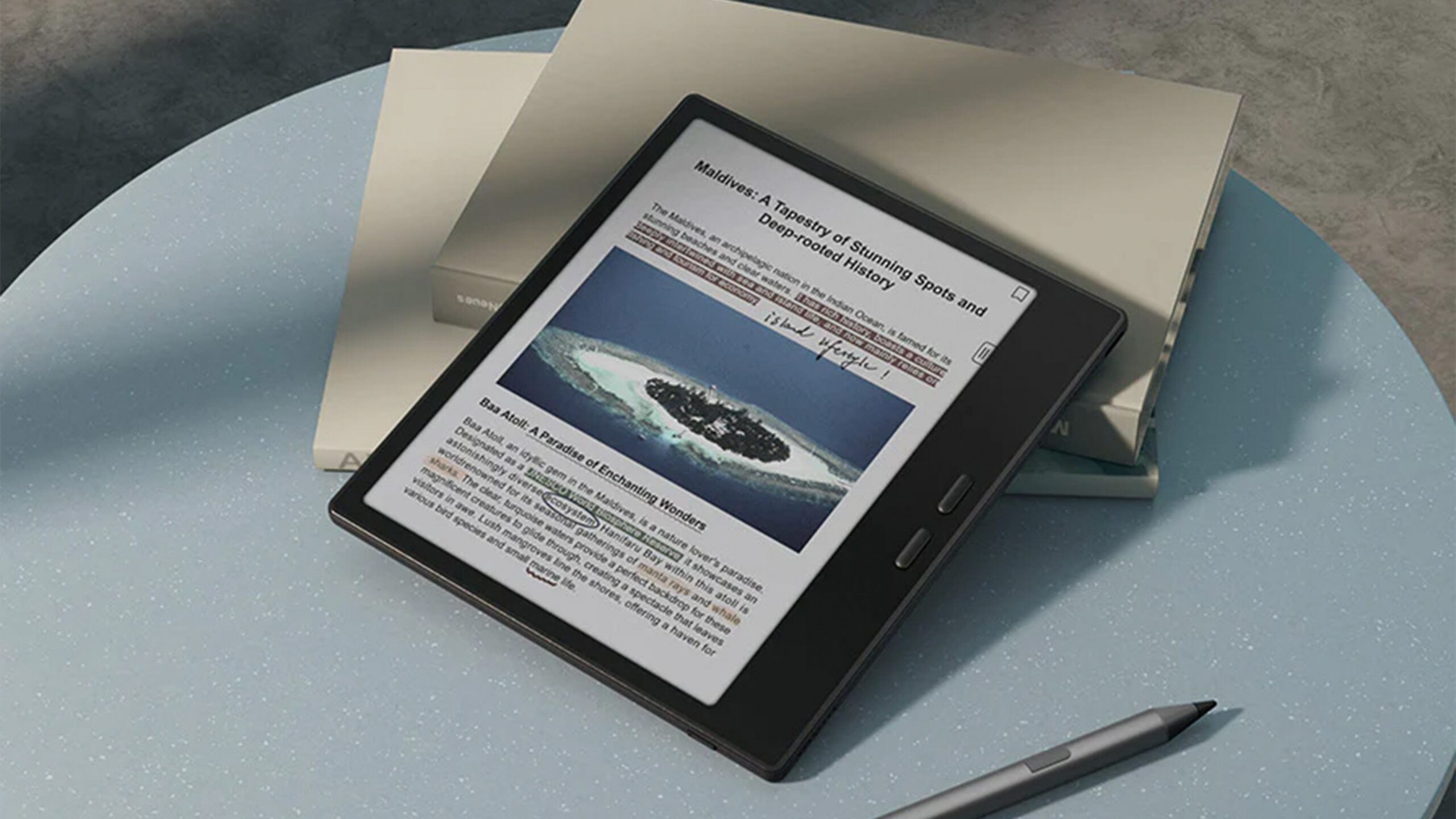 A Boox Go 7 rests on a surface alongside its stylus.