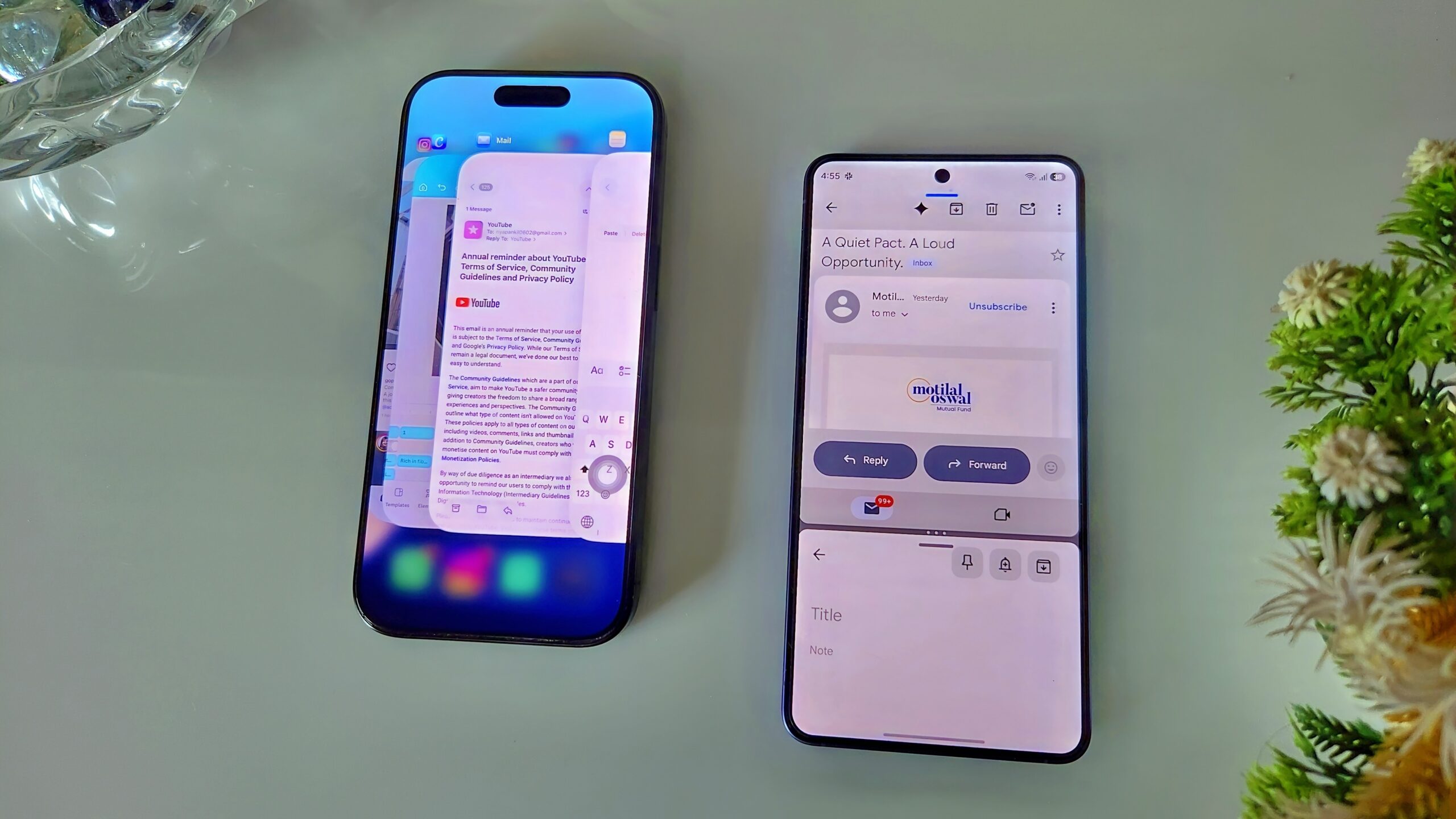 iPhone and Samsung phone side by side on a white table