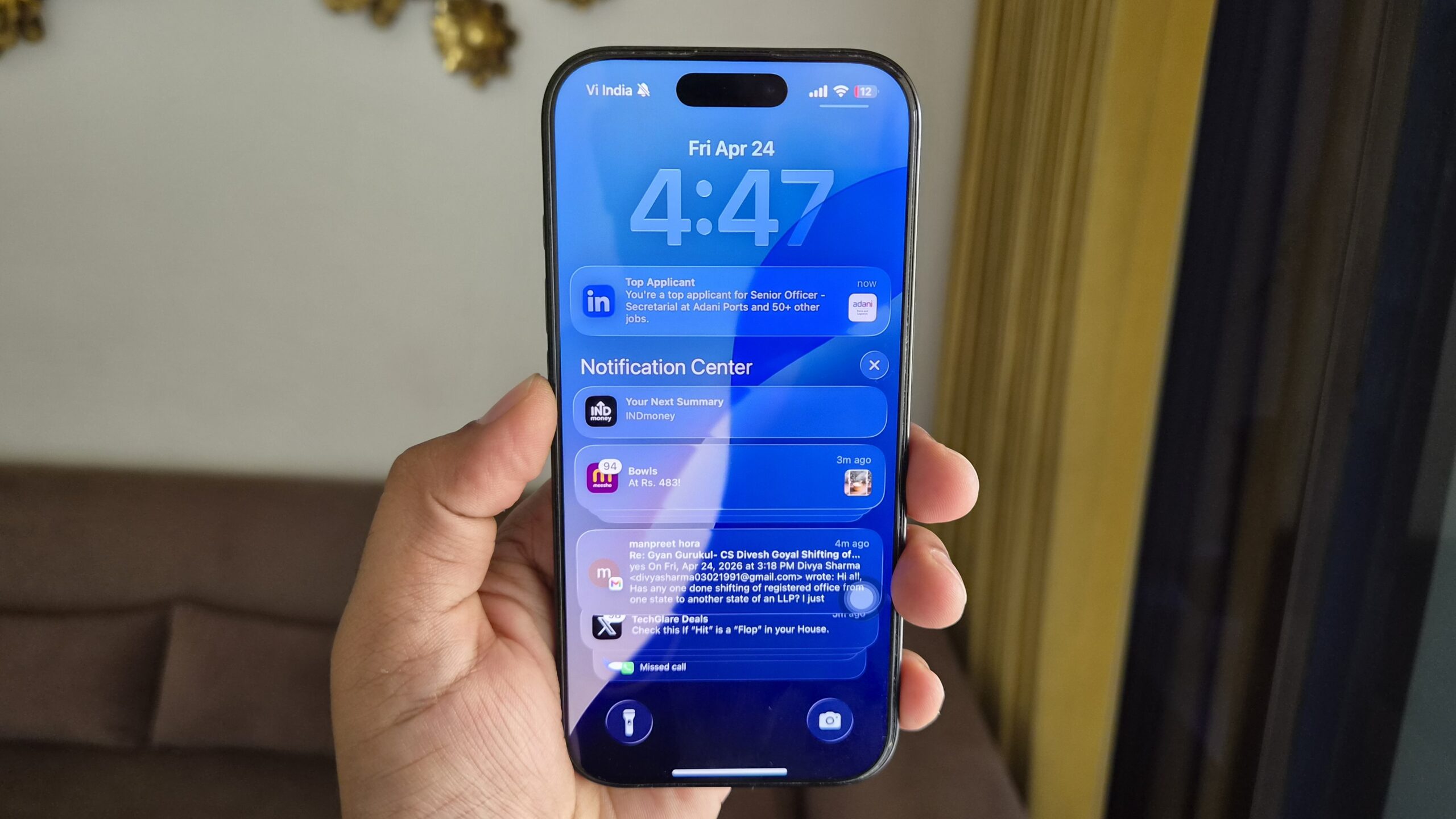 iPhone in hand showing notification center