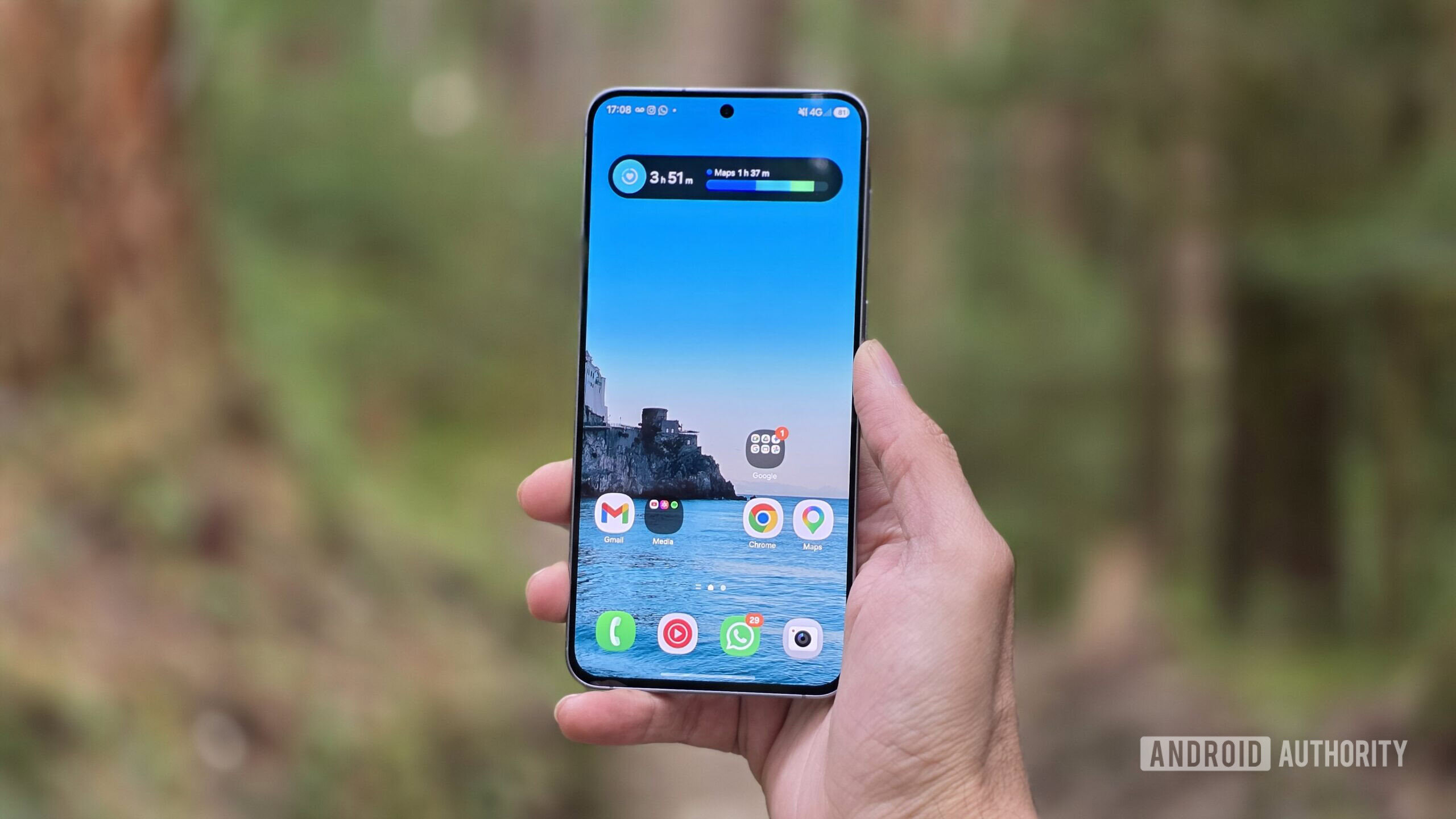 Samsung Galaxy A57 review image showing the phone in hand in an outdoor setting