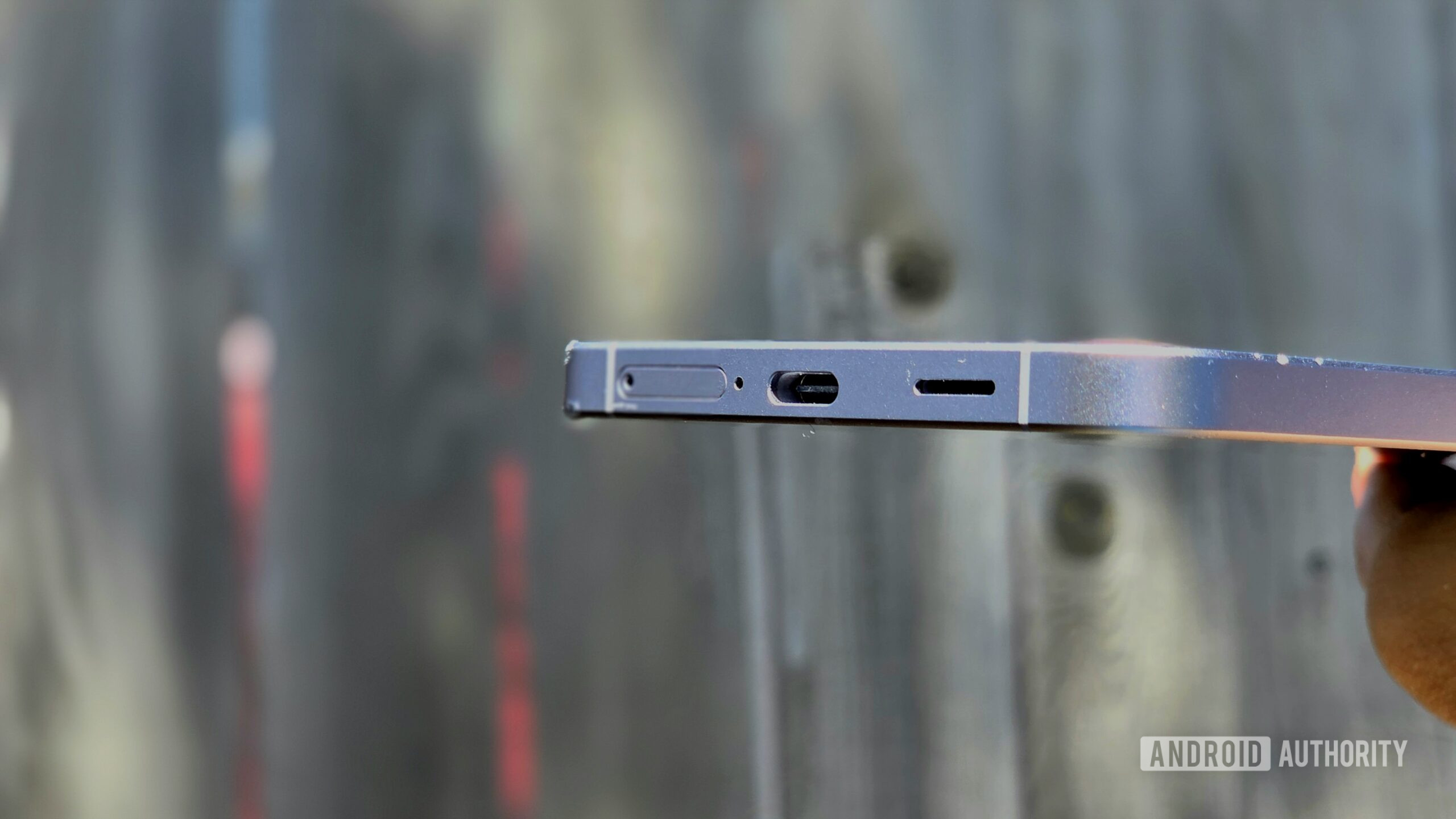 Samsung Galaxy A57 5G review image showing the phone's bottom edge housing the USB-C port, SIM tray, and speaker grille