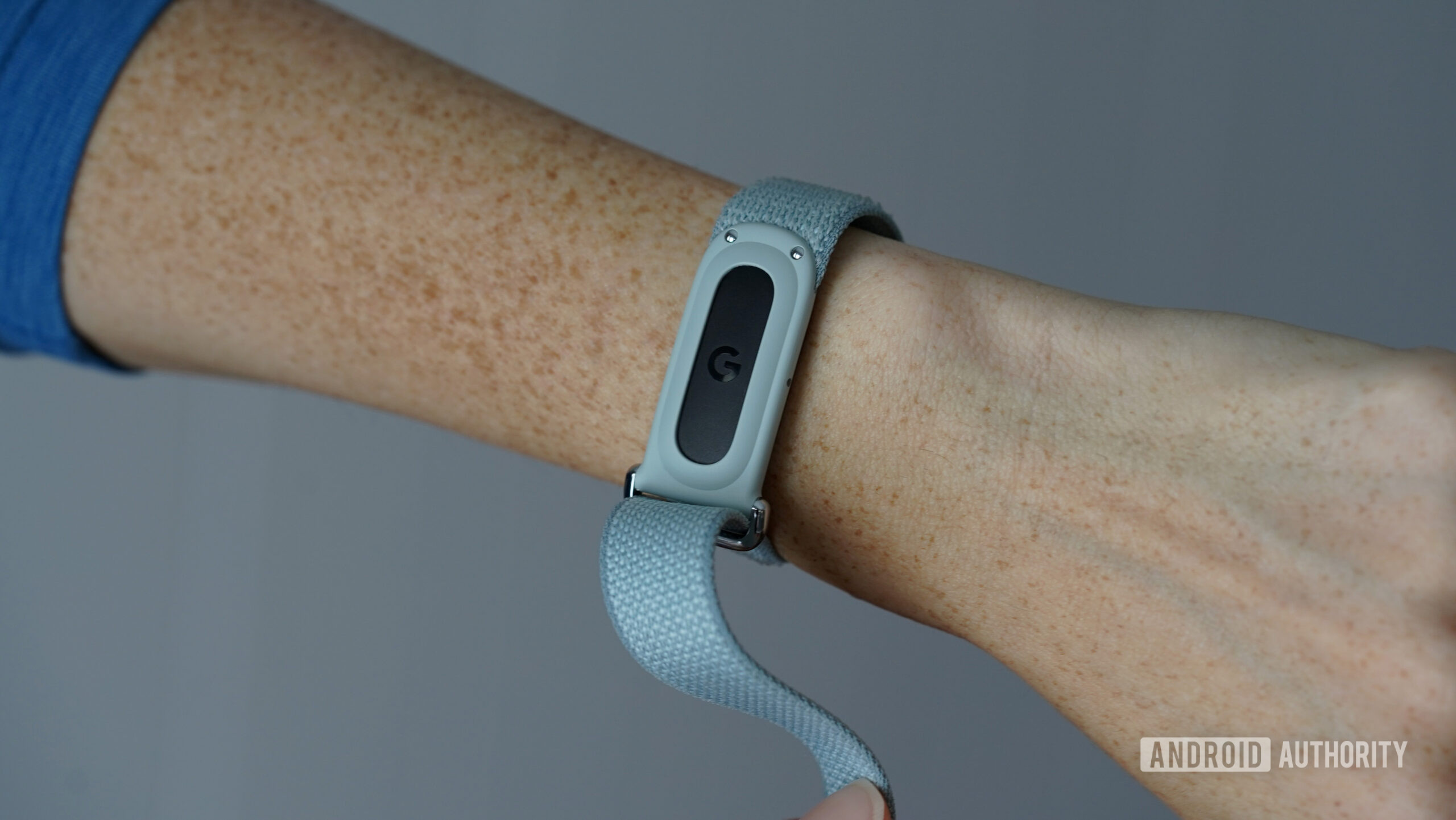 A Google Fitbit Air on a user's wrist equips a nylon strap.