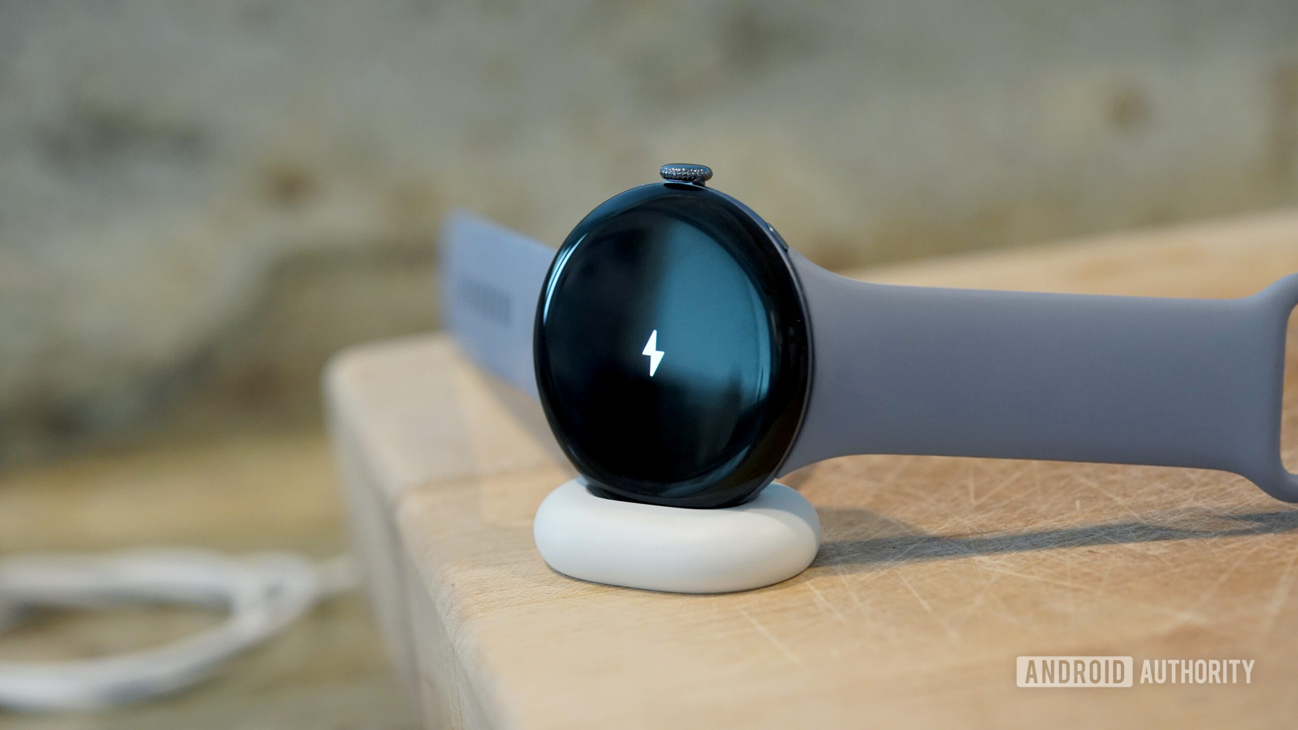 Google Pixel Watch 4 Charging A Google Pixel Watch 4 rests on its charger.