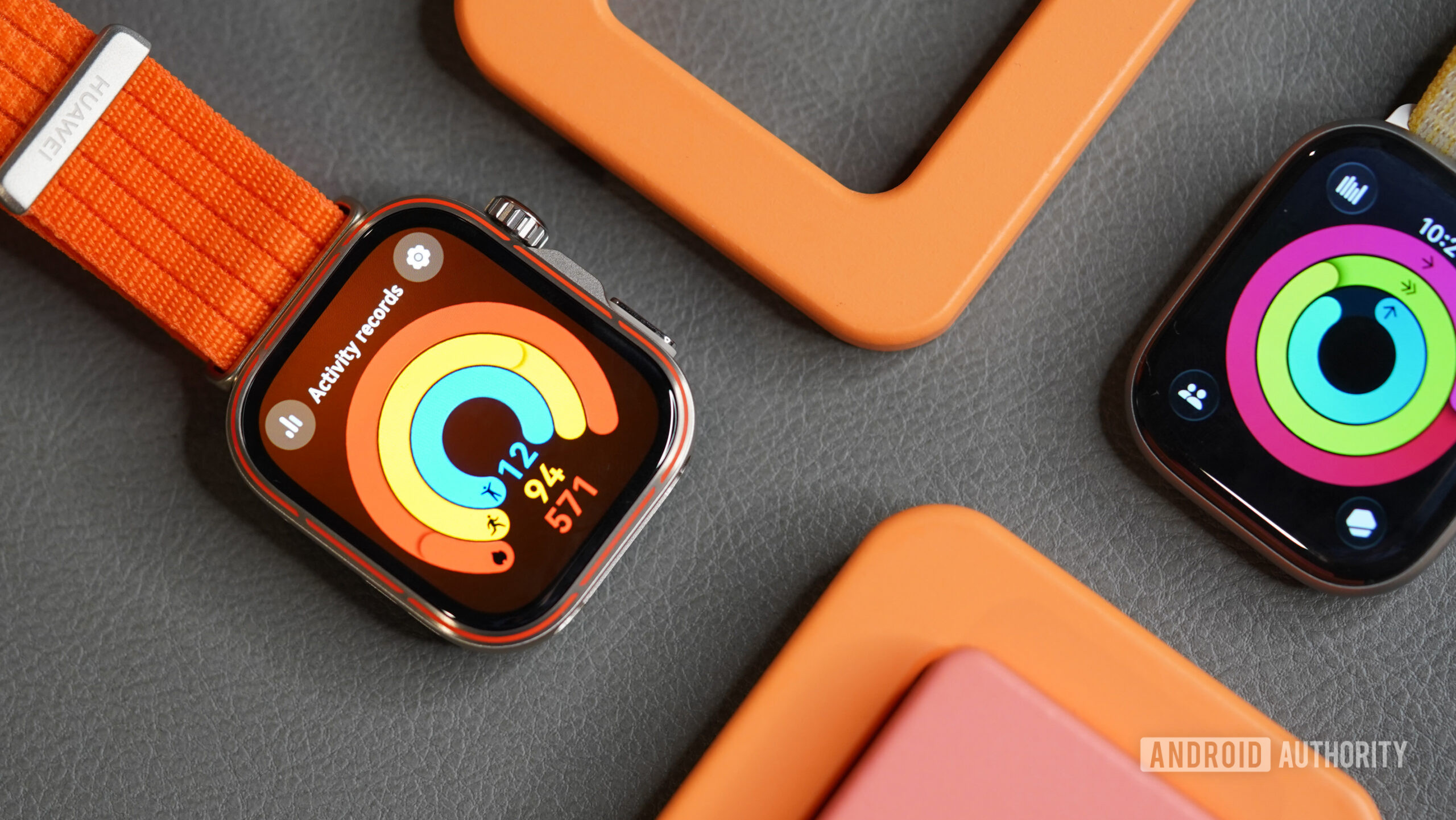 A HUAWEI Watch Fit 5 Pro rests next to an Apple Watch Series 11.