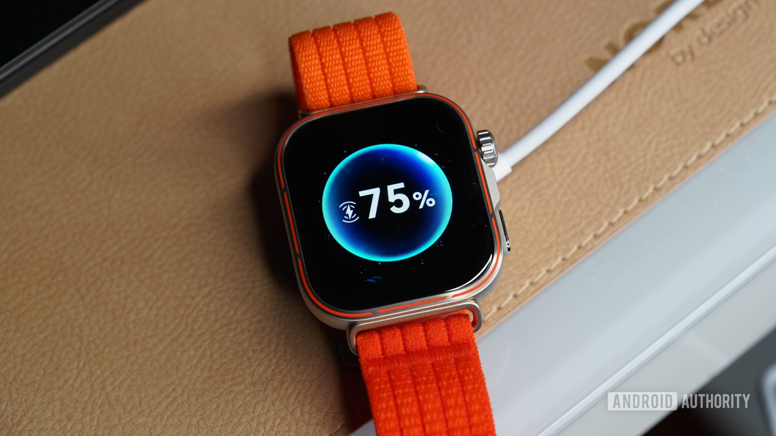 The HUAWEI Watch Fit 5 Pro rests on its charger.