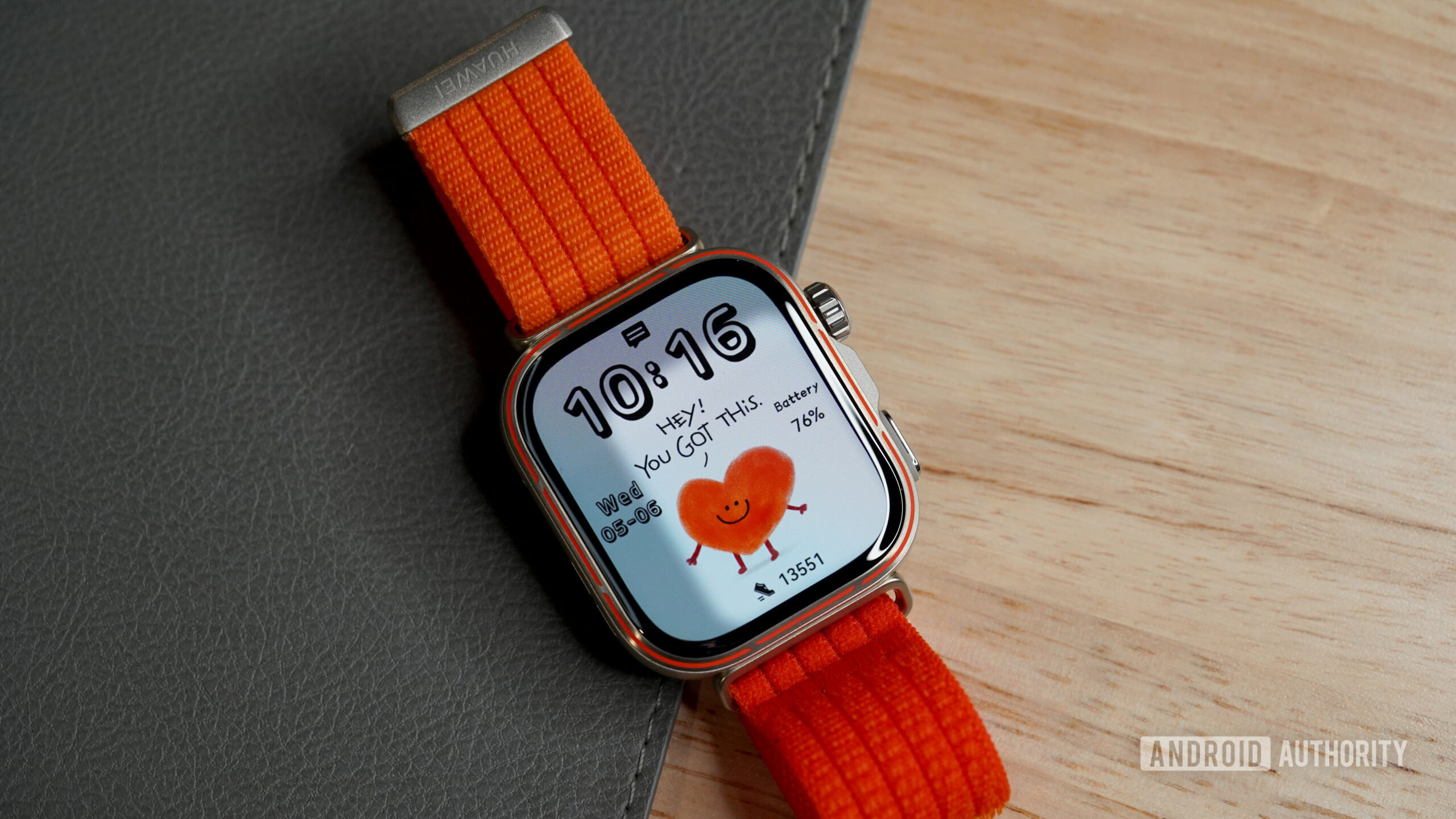 A HUAWEI Watch Fit 5 Pro displays a cheeky heart watch face.