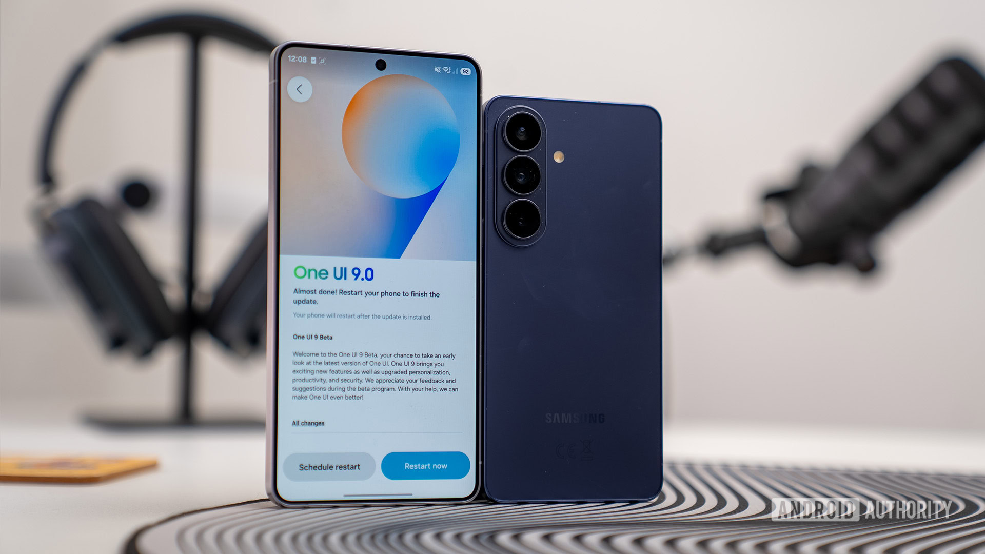 OneUI 9 update screen on S26 Ultra stood next to base S26 on an angle OneUI 9 update screen on S26 Ultra stood next to base S26 on an angle
