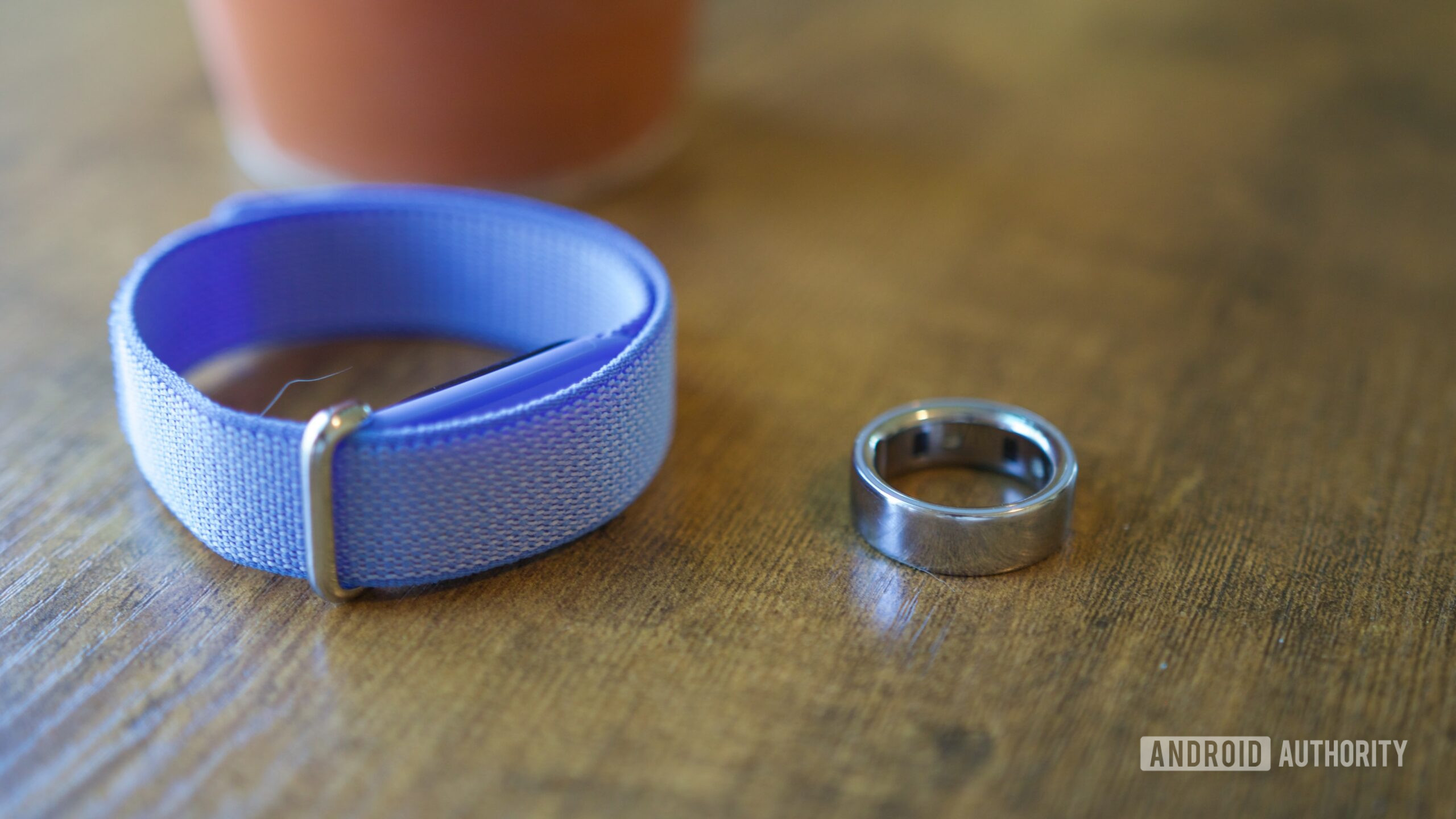 google fitbit air oura ring 4 on table The Fitbit Air and Oura Ring 4 lying on a table.