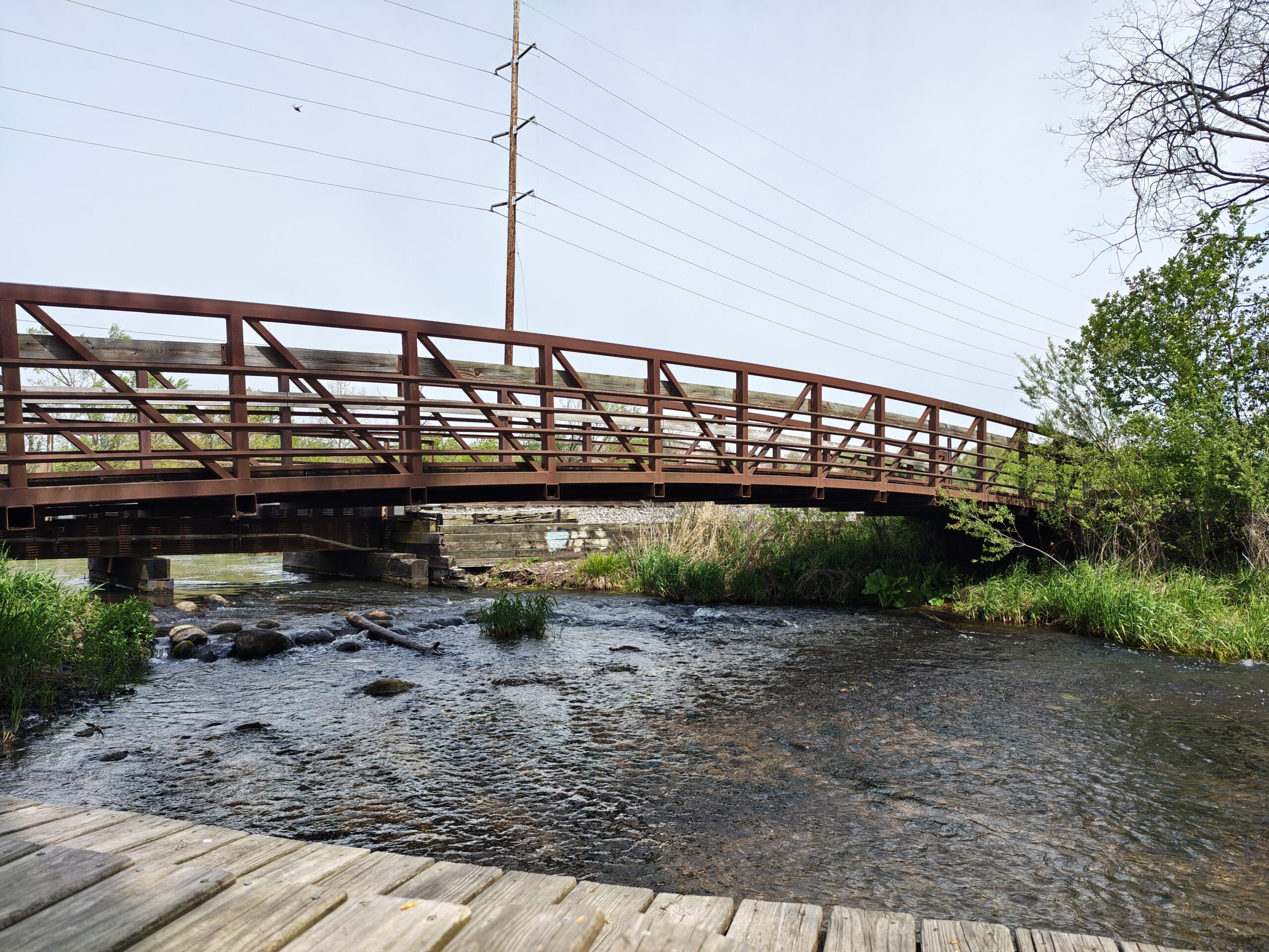 A photo of a bridge and a small creek, taken with the Motorola Razr Fold.