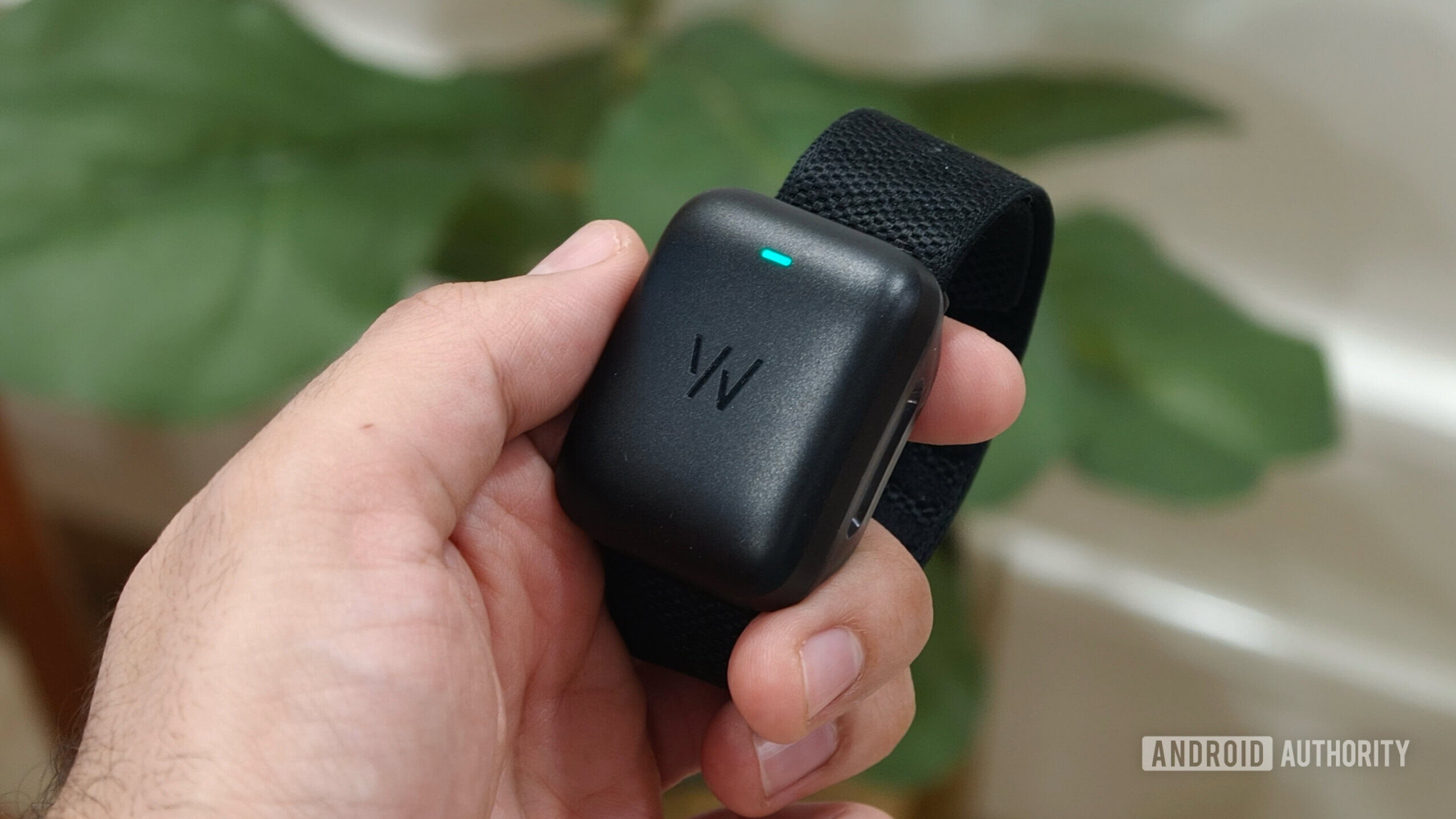 Someone holding the WHOOP MG.