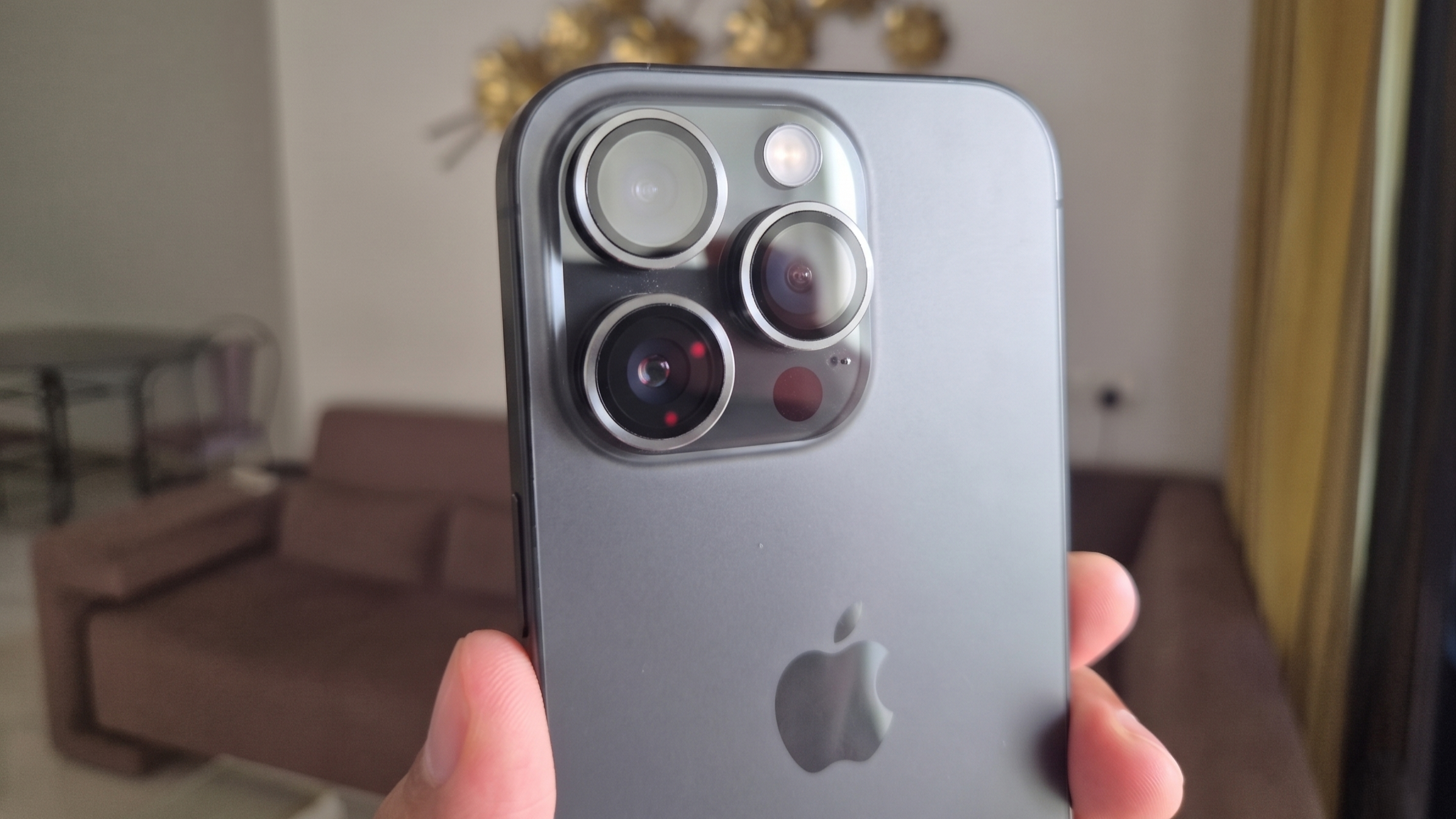 A black iPhone 16 Pro in hand