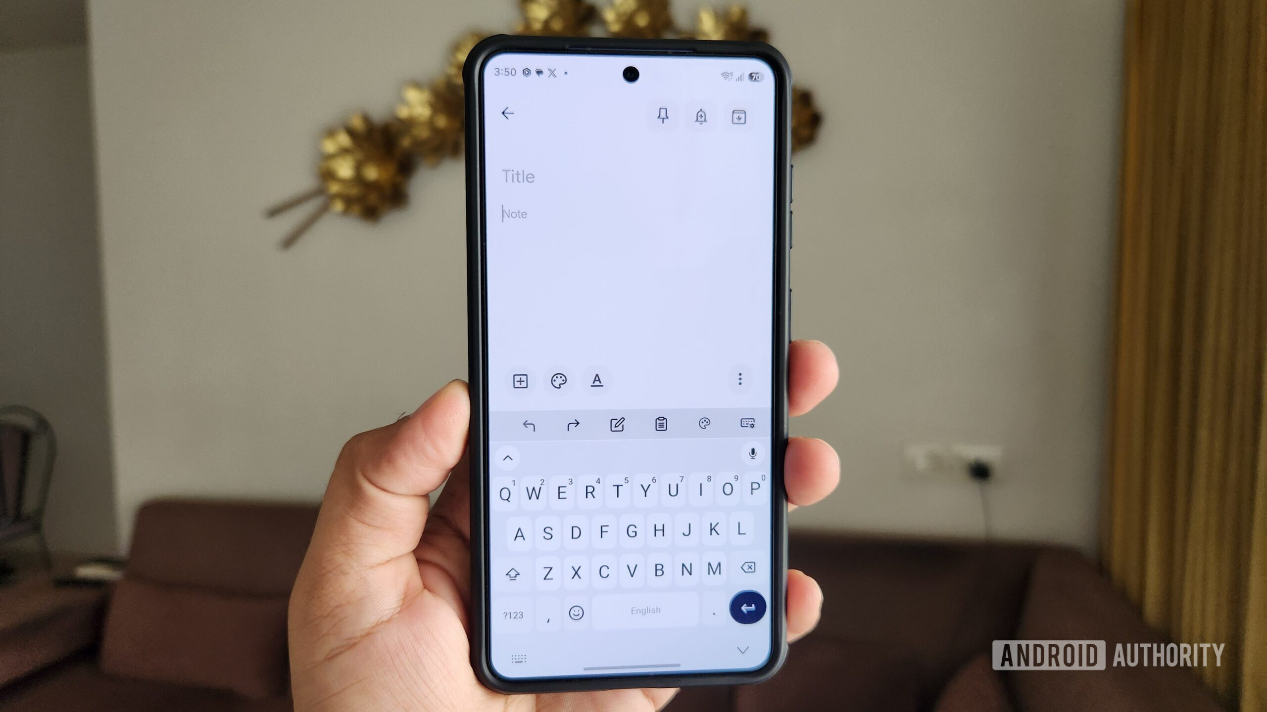 Android phone in hand showing FUTO Keyboard app