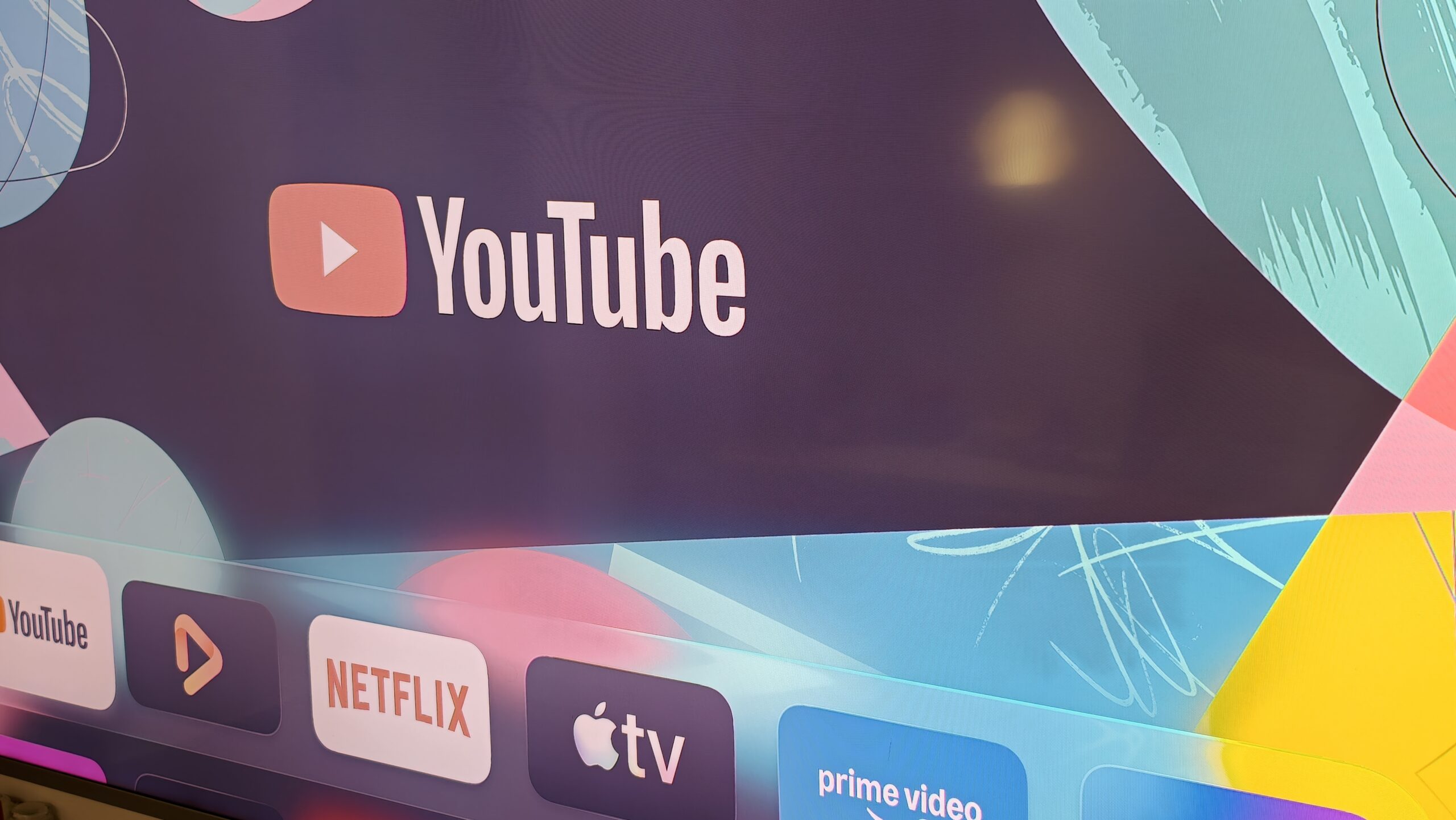 Apple TV interface with the YouTube app highlighted.