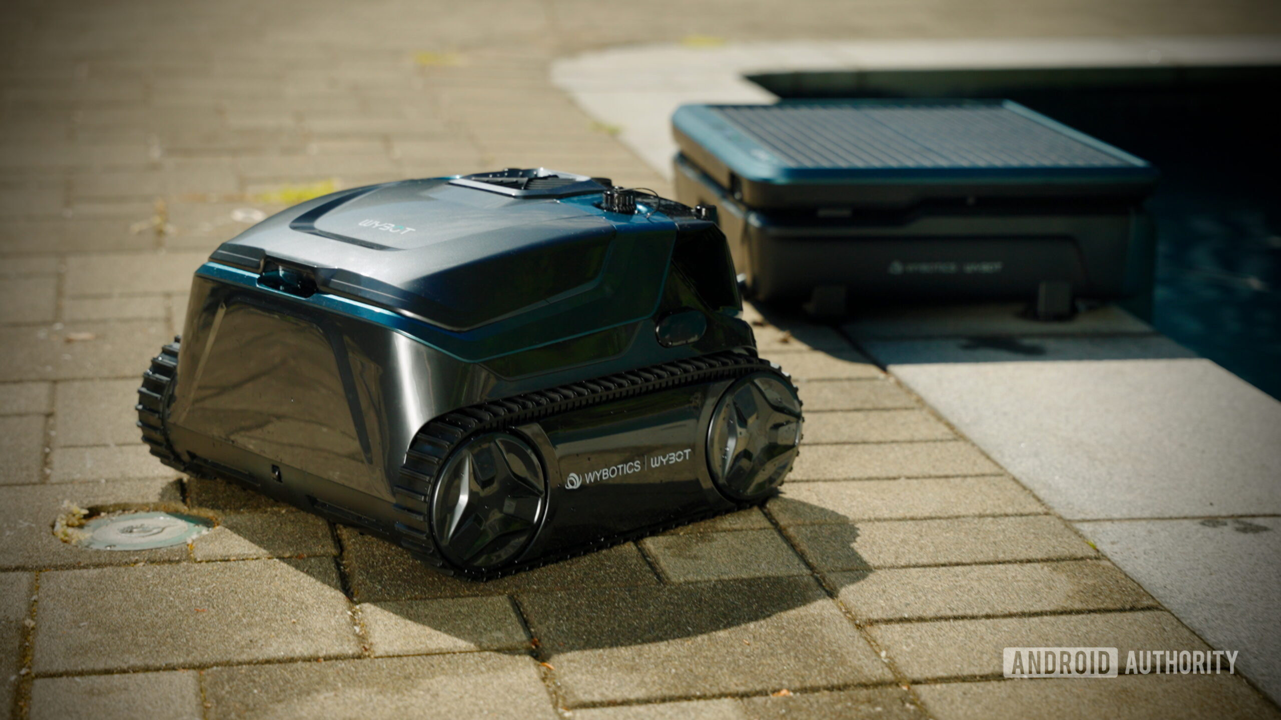 WYBOT S3 Robot Pool Cleaner 1 (1) WYBOT S3 robot pool cleaner parked beside its solar charging station