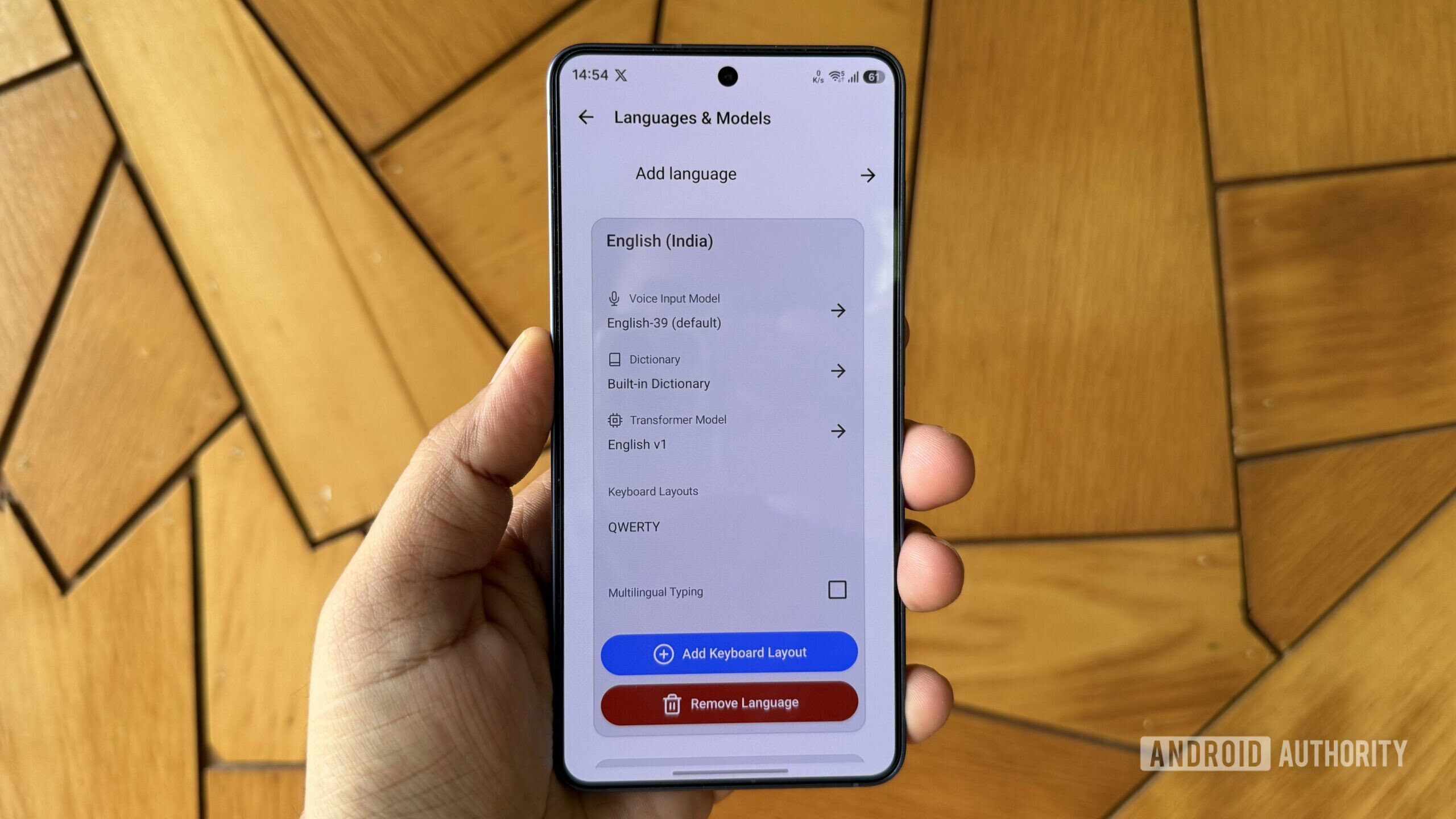 Android phone in hand showing FUTO language models
