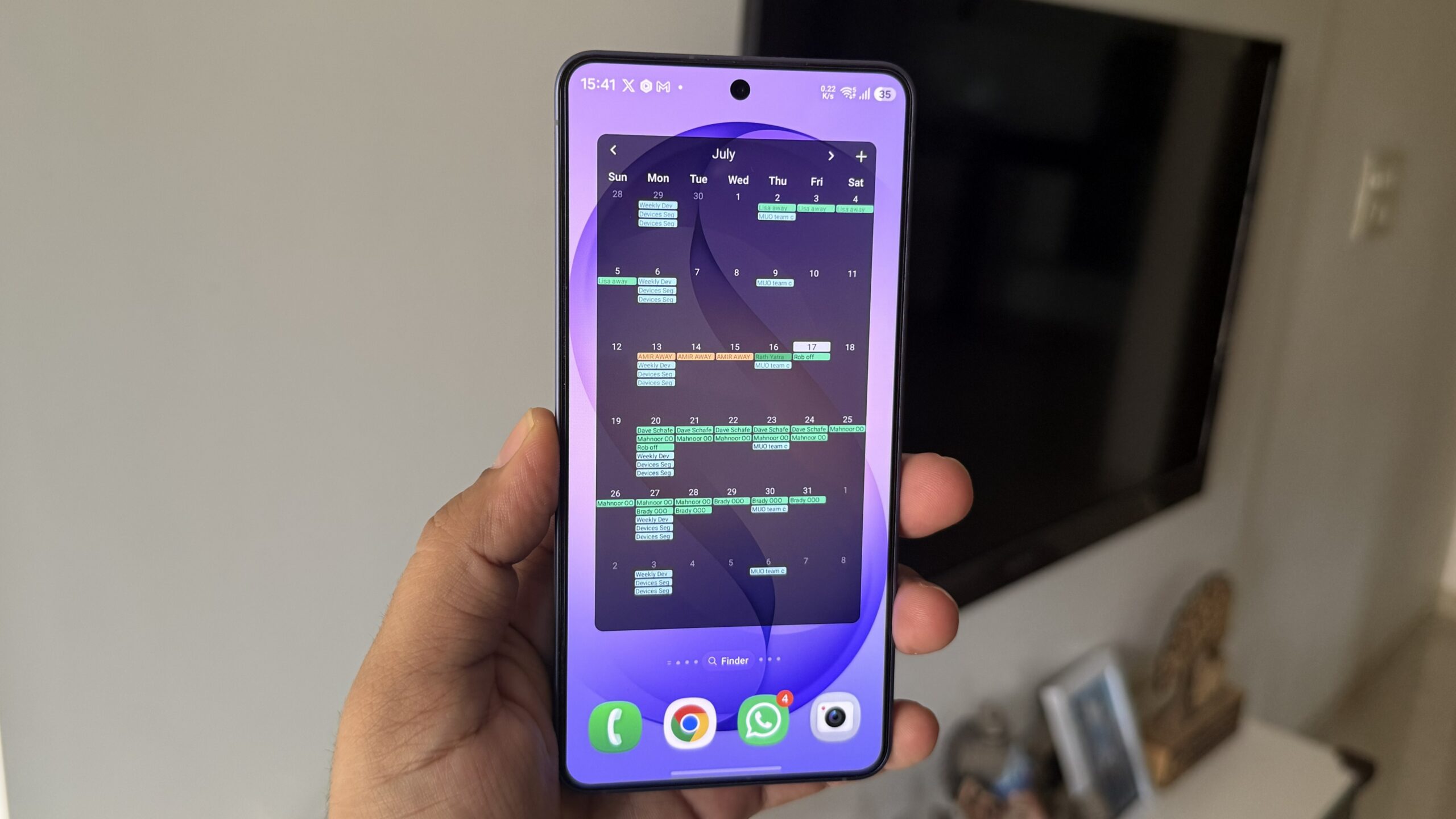 Android phone in hand showing Fossify Calendar widget