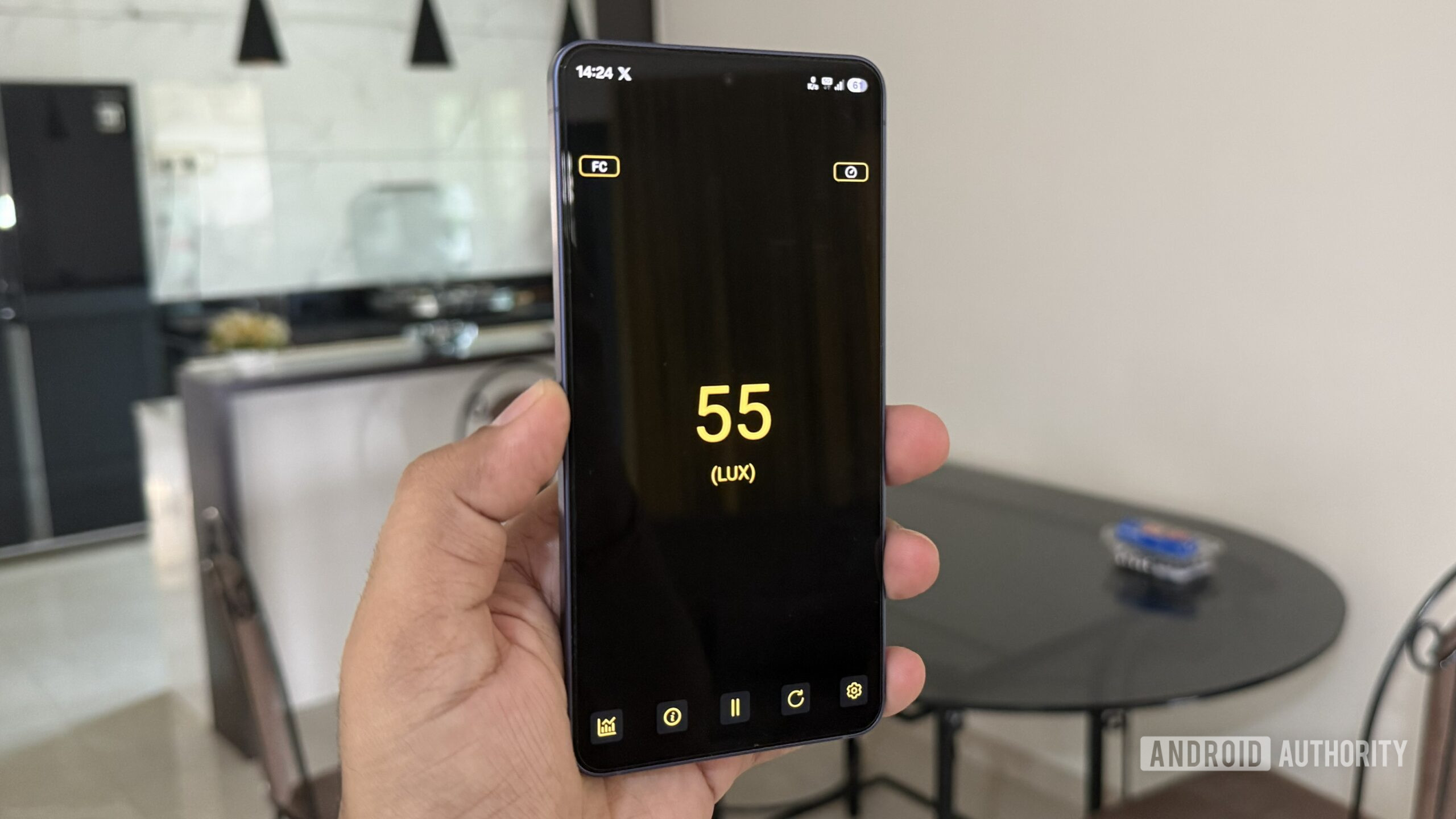 Android phone in hand showing Light Meter app Android phone in hand showing Light Meter app