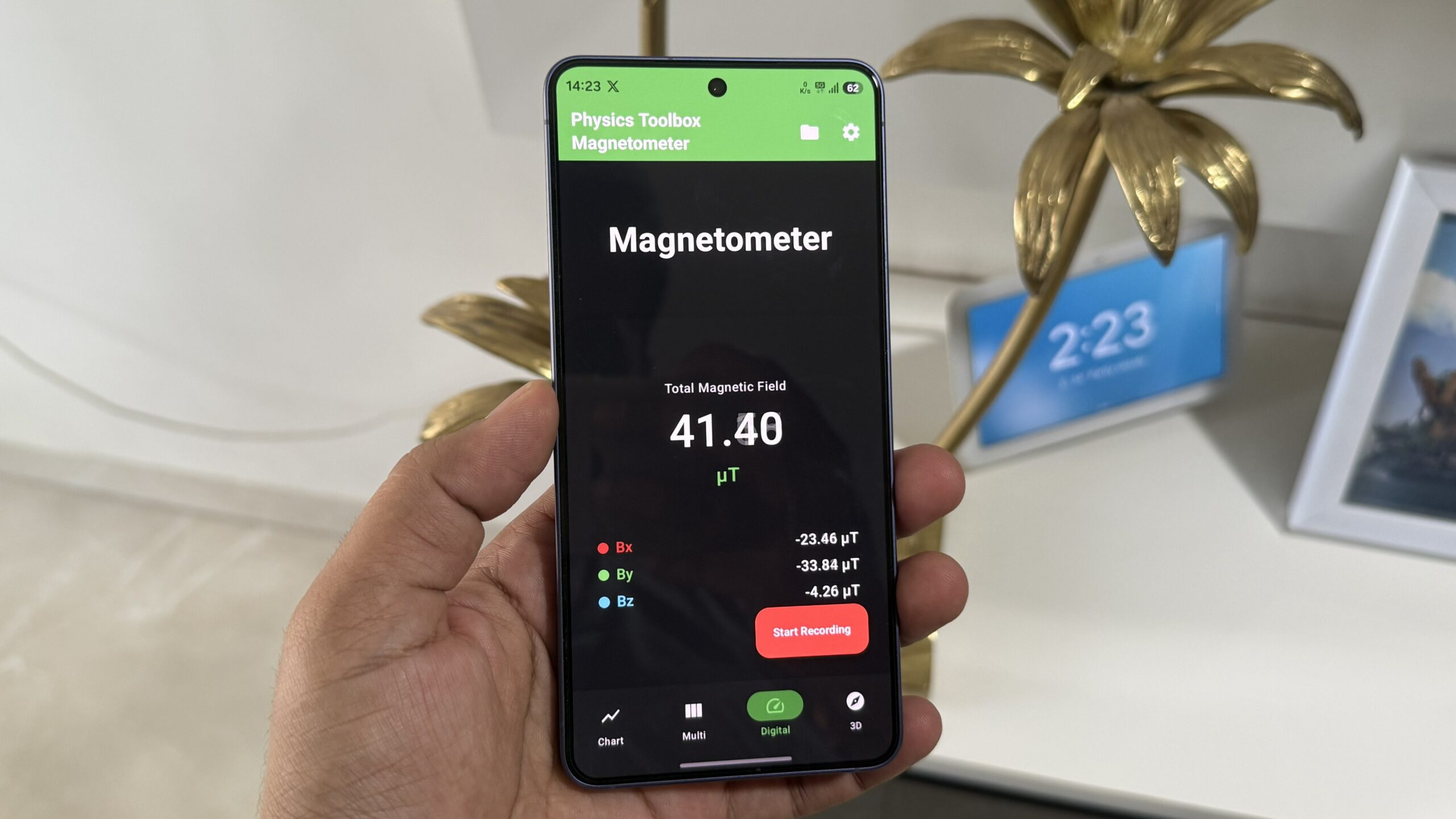 Android phone in hand showing magnetometer app Android phone in hand showing magnetometer app