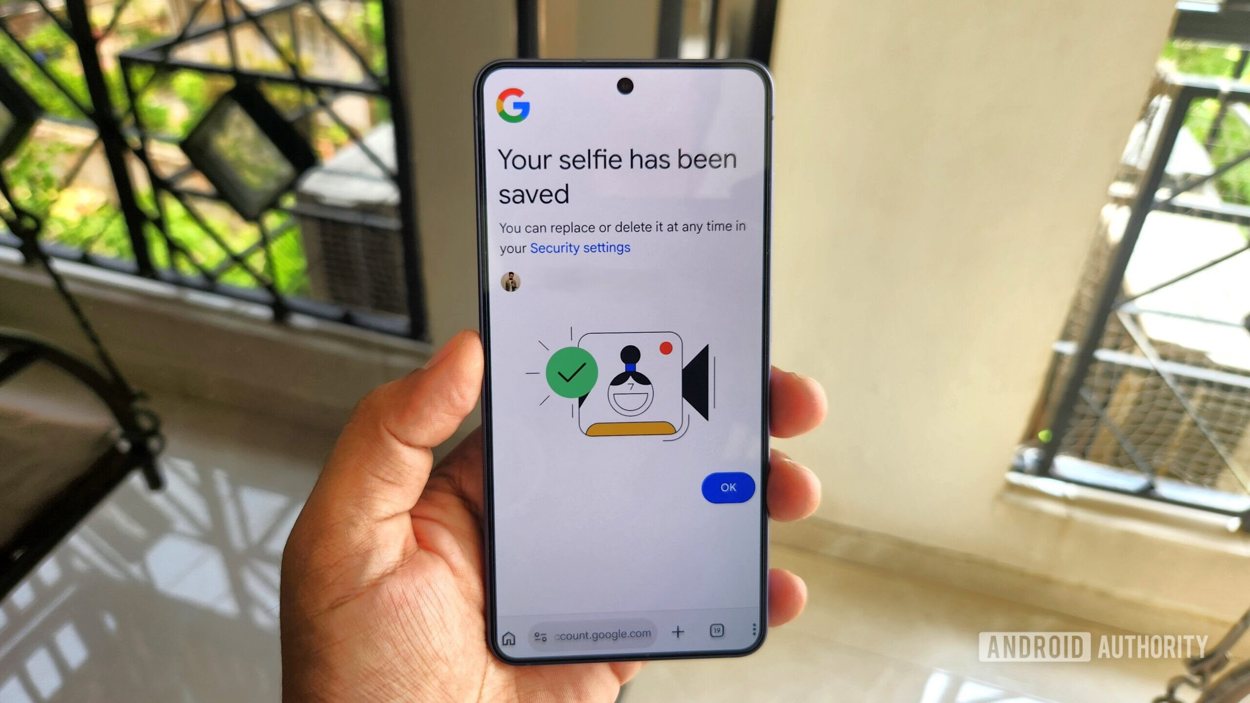 Android phone in hand showing selfie video feature Android phone in hand showing selfie video feature