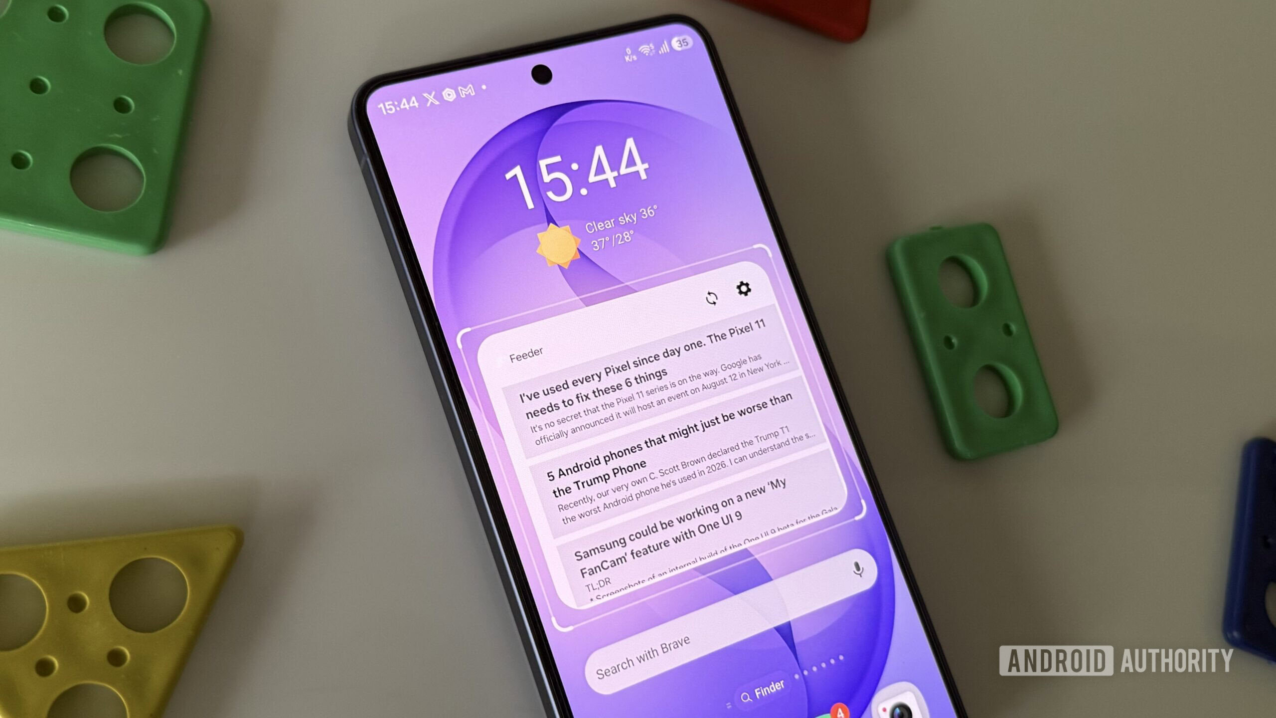 Android phone on a white surface showing Feeder widget