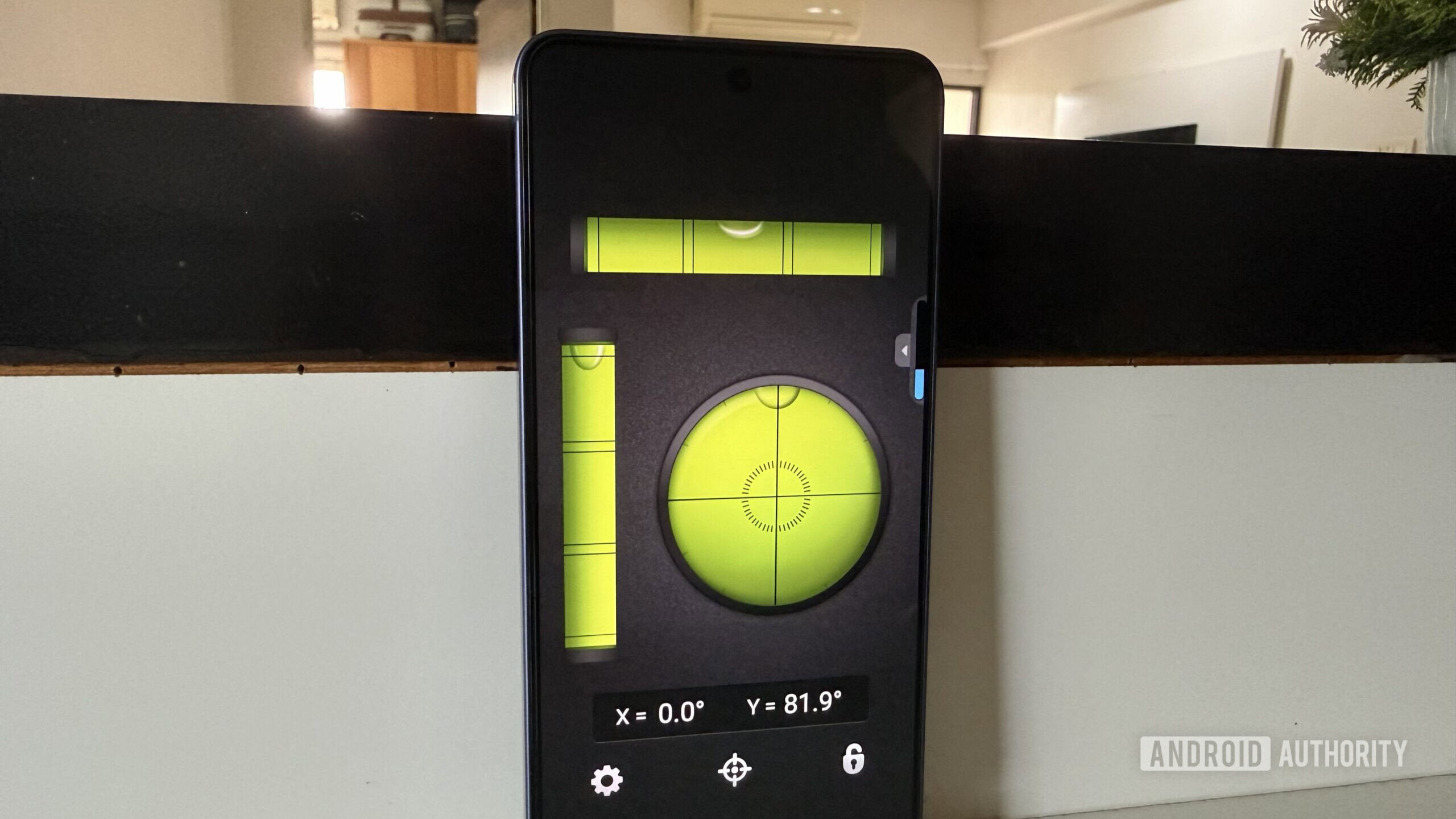 Android phone standing upright showing bubble level app Android phone standing upright showing bubble level app