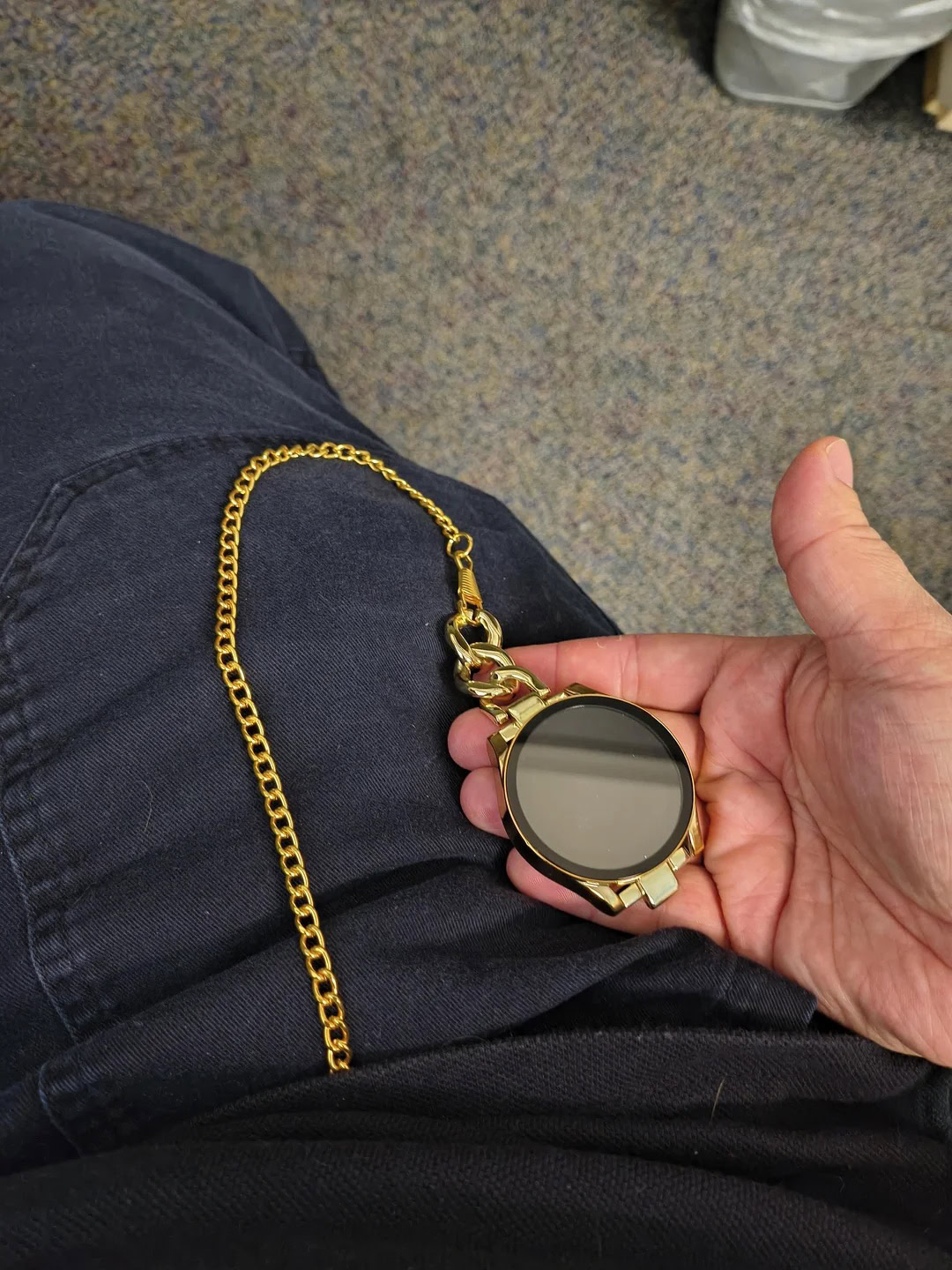 An image of a Galaxy Watch connected to a pocket watch chain.