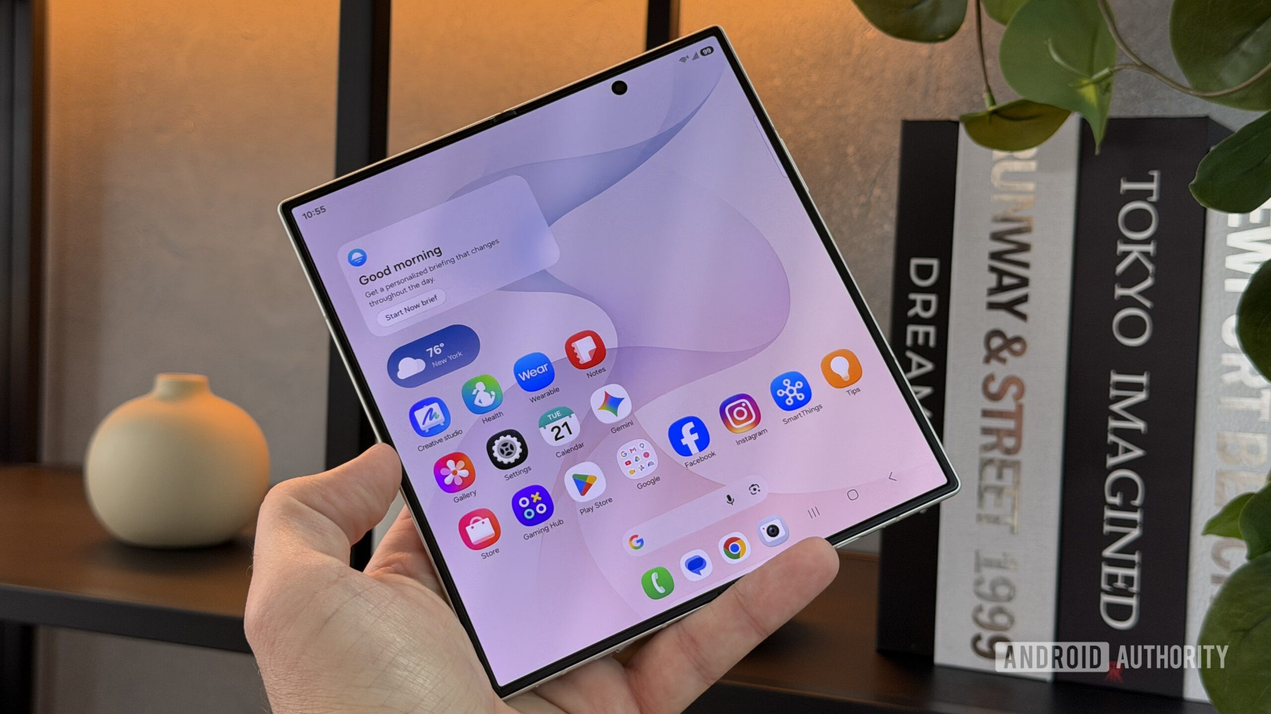 Samsung Galaxy Z Fold 8 Ultra unfolded against shelves Samsung Galaxy Z Fold 8 Ultra unfolded against shelves