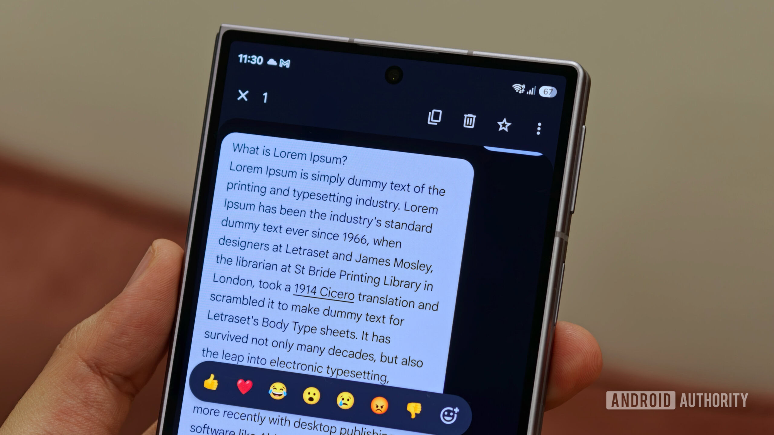google messages copy Close-up of a smartphone screen running Google Messages, showing an emoji reaction bar over a selected text message bubble